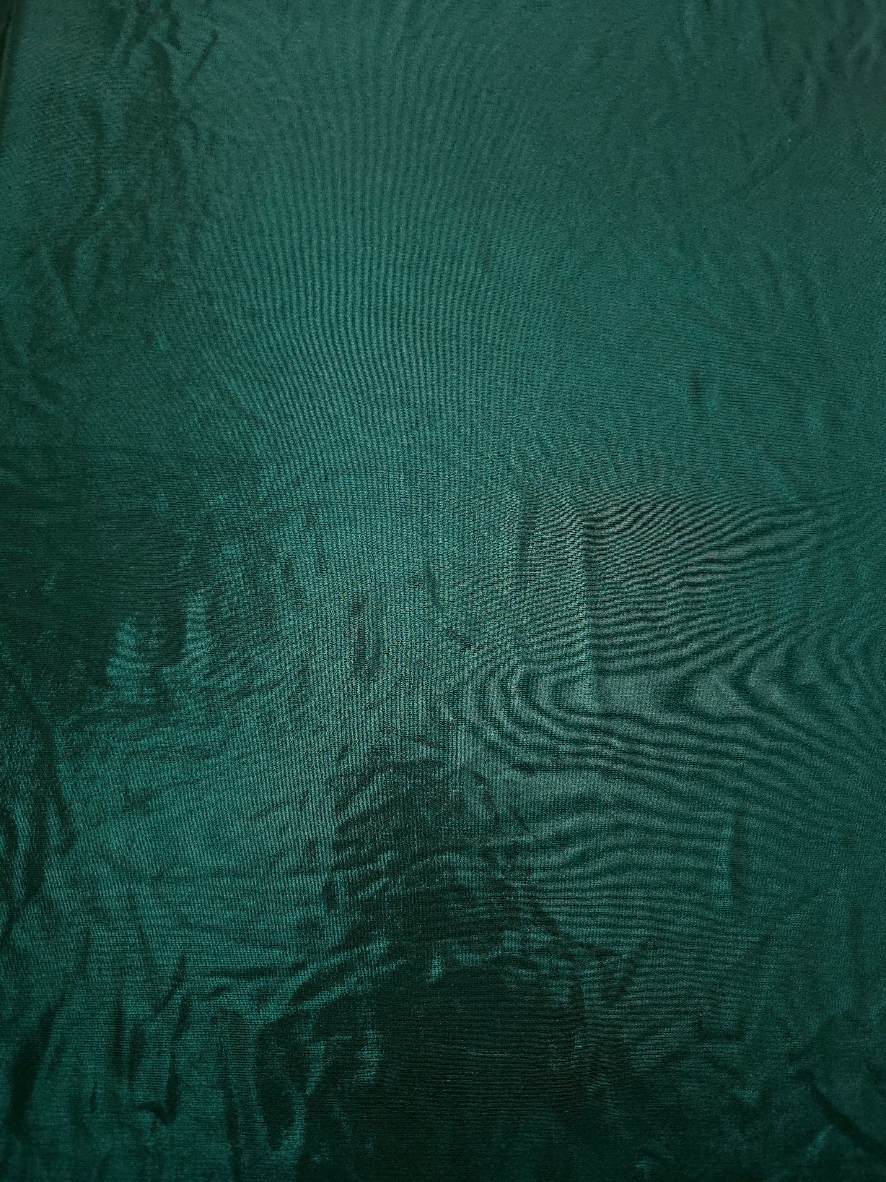 Deep Teal Green metallic foiled spandex shown flat, reflective stretch fabric for dancewear, eveningwear and statement garments