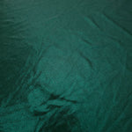Close-up of Deep Teal Green metallic foiled spandex showing reflective surface texture and the detailed shimmer finish