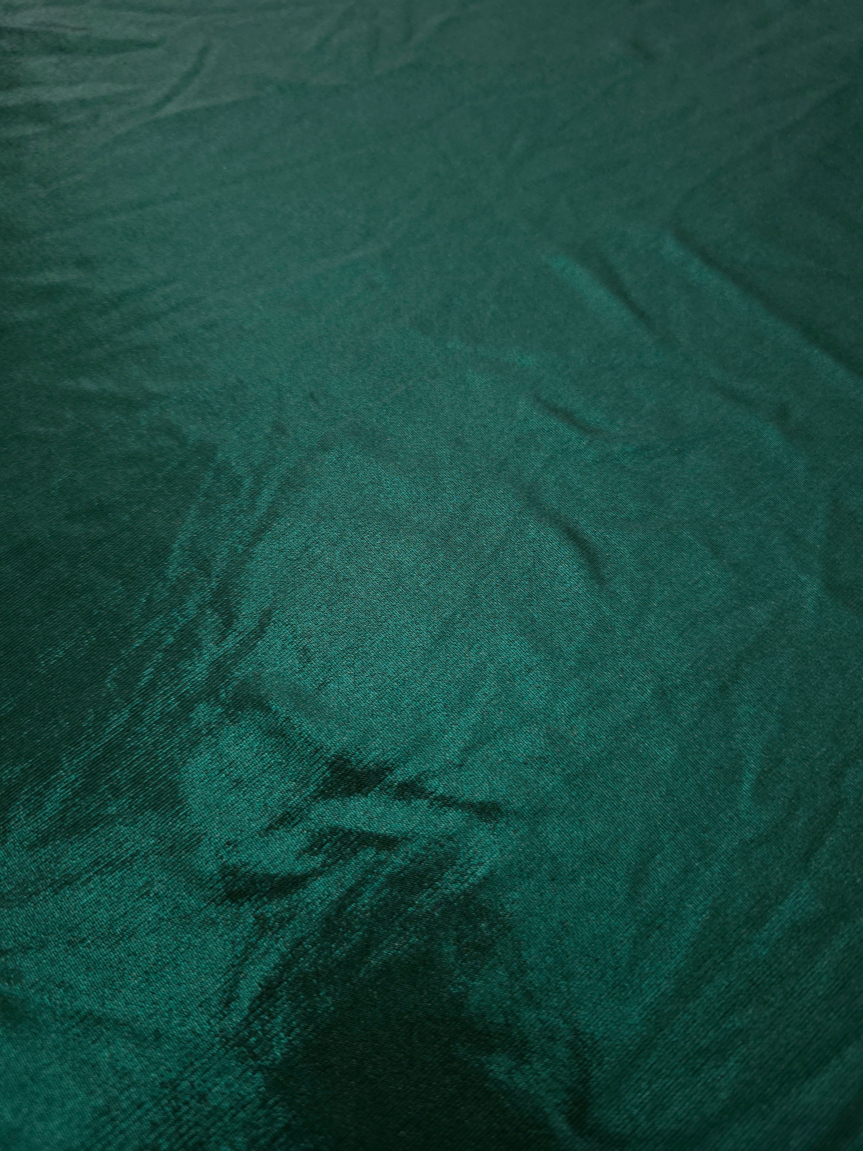 Close-up of Deep Teal Green metallic foiled spandex showing reflective surface texture and the detailed shimmer finish
