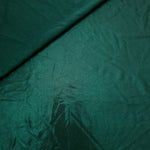 Deep Teal Green shimmer spandex in a soft fold, showing metallic foil sheen and flexible drape for tops, skirts and costumes