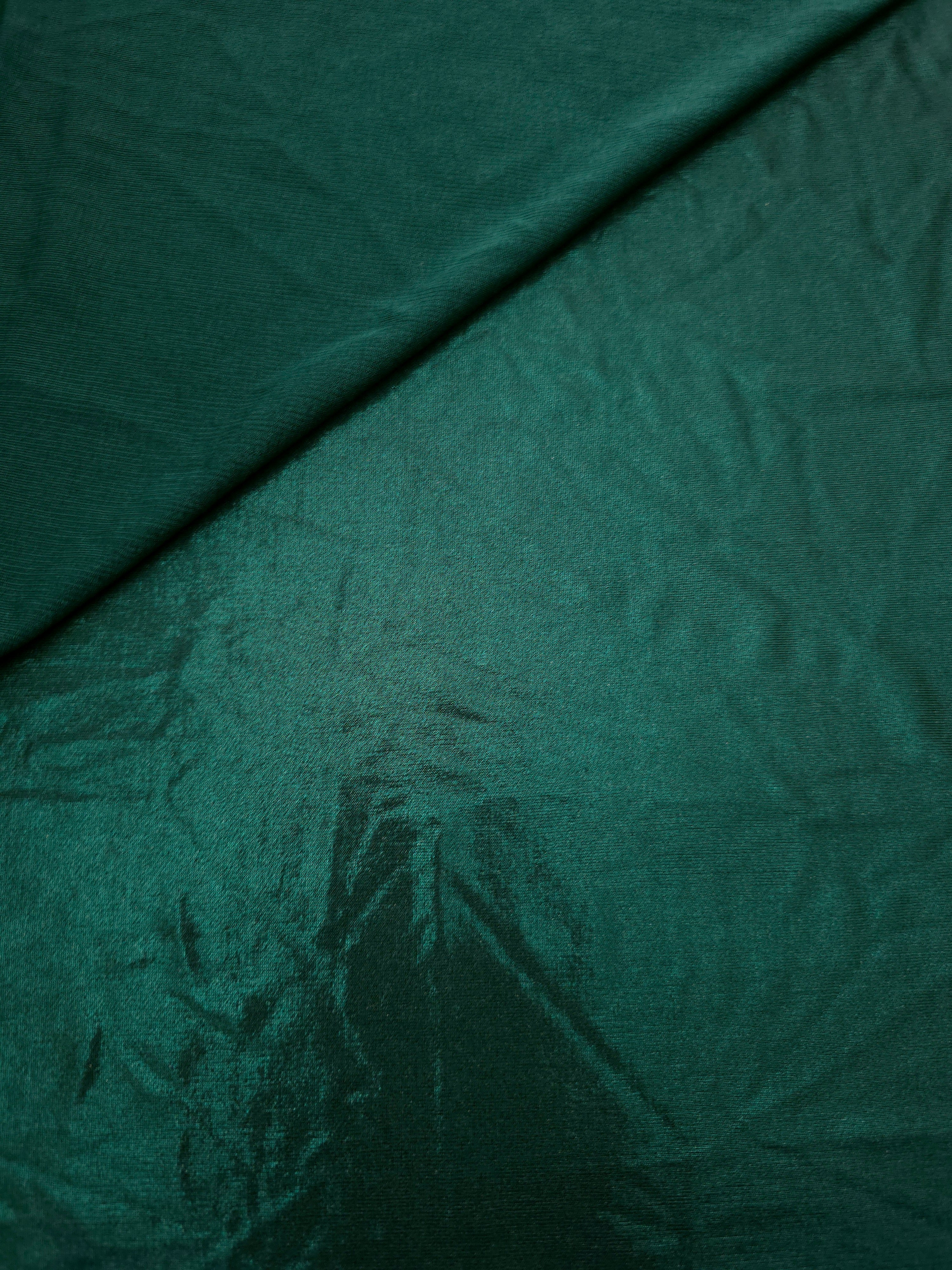 Deep Teal Green shimmer spandex in a soft fold, showing metallic foil sheen and flexible drape for tops, skirts and costumes