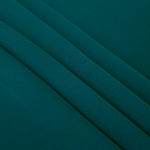 Layered Deep Teal Korean polyester crepe showing gentle mechanical stretch and soft structure for dressmaking