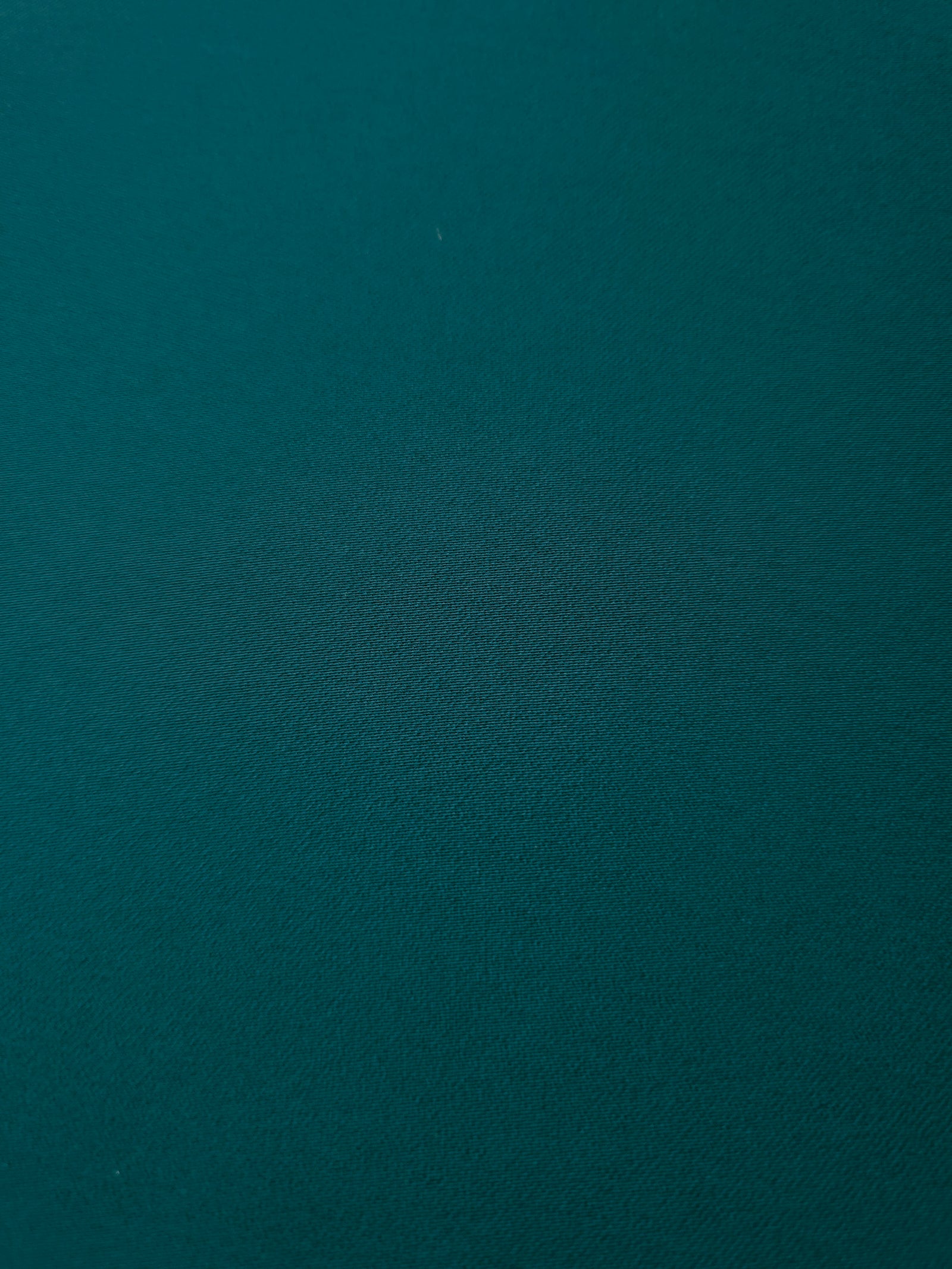 Deep Teal mechanical polyester crepe in close-up, showing fine woven texture and a silky-soft surface