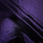 Deep Violet Purple shimmer spandex fabric stacked in soft layers, revealing metallic reflection for costumes, dresses and creative apparel