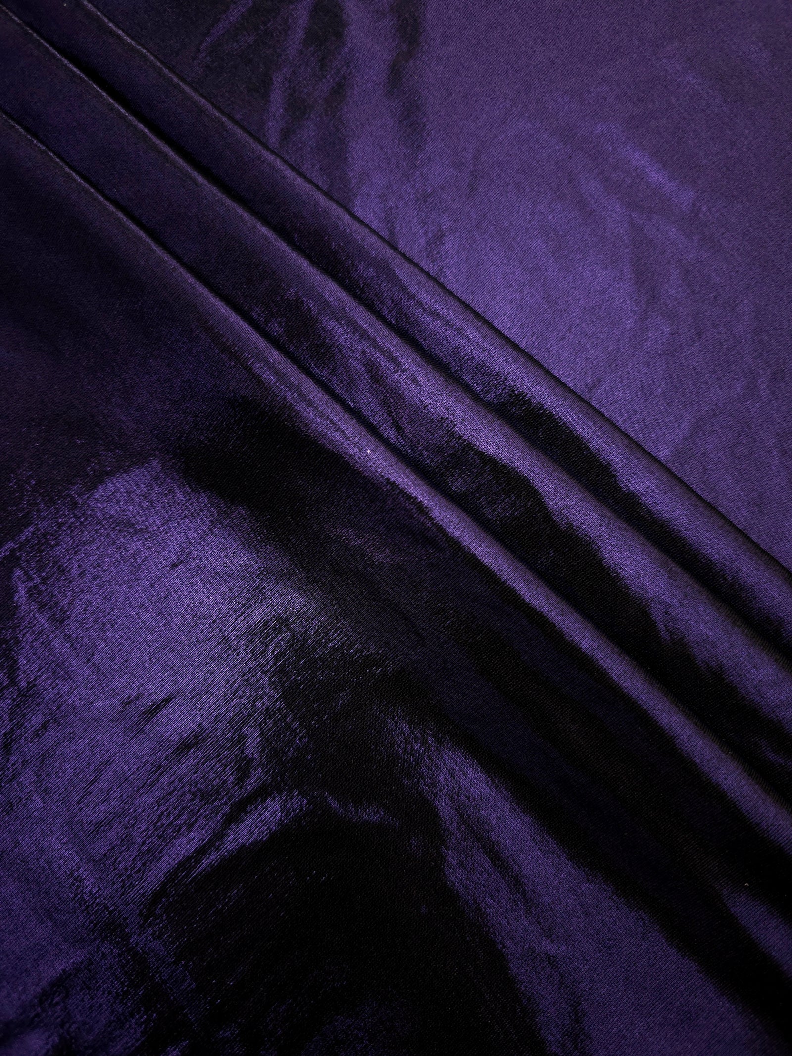 Deep Violet Purple shimmer spandex fabric stacked in soft layers, revealing metallic reflection for costumes, dresses and creative apparel