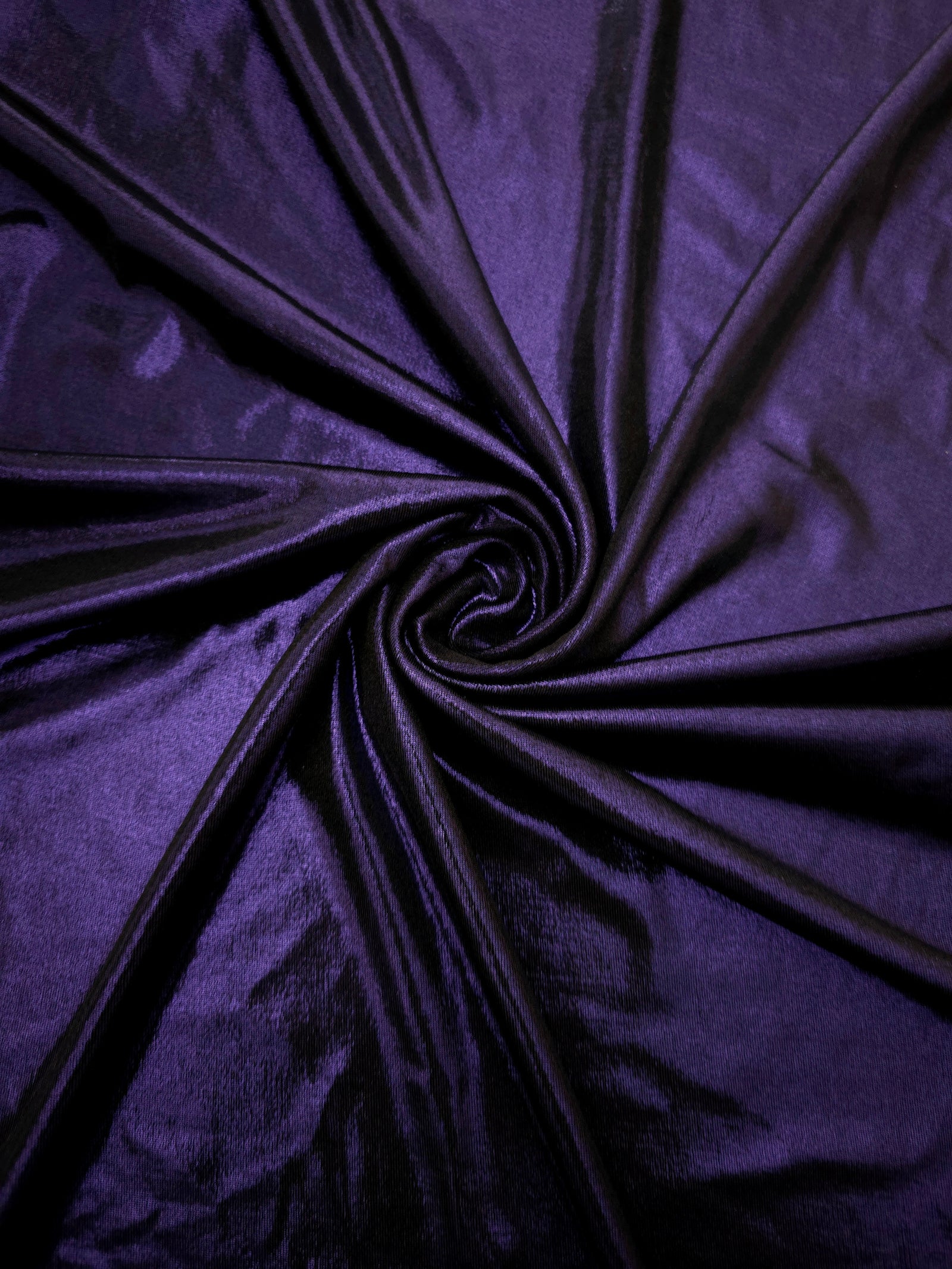 Spiraled Deep Violet Purple shimmer spandex fabric showing reflective movement for evening dresses, costumes and performance apparel