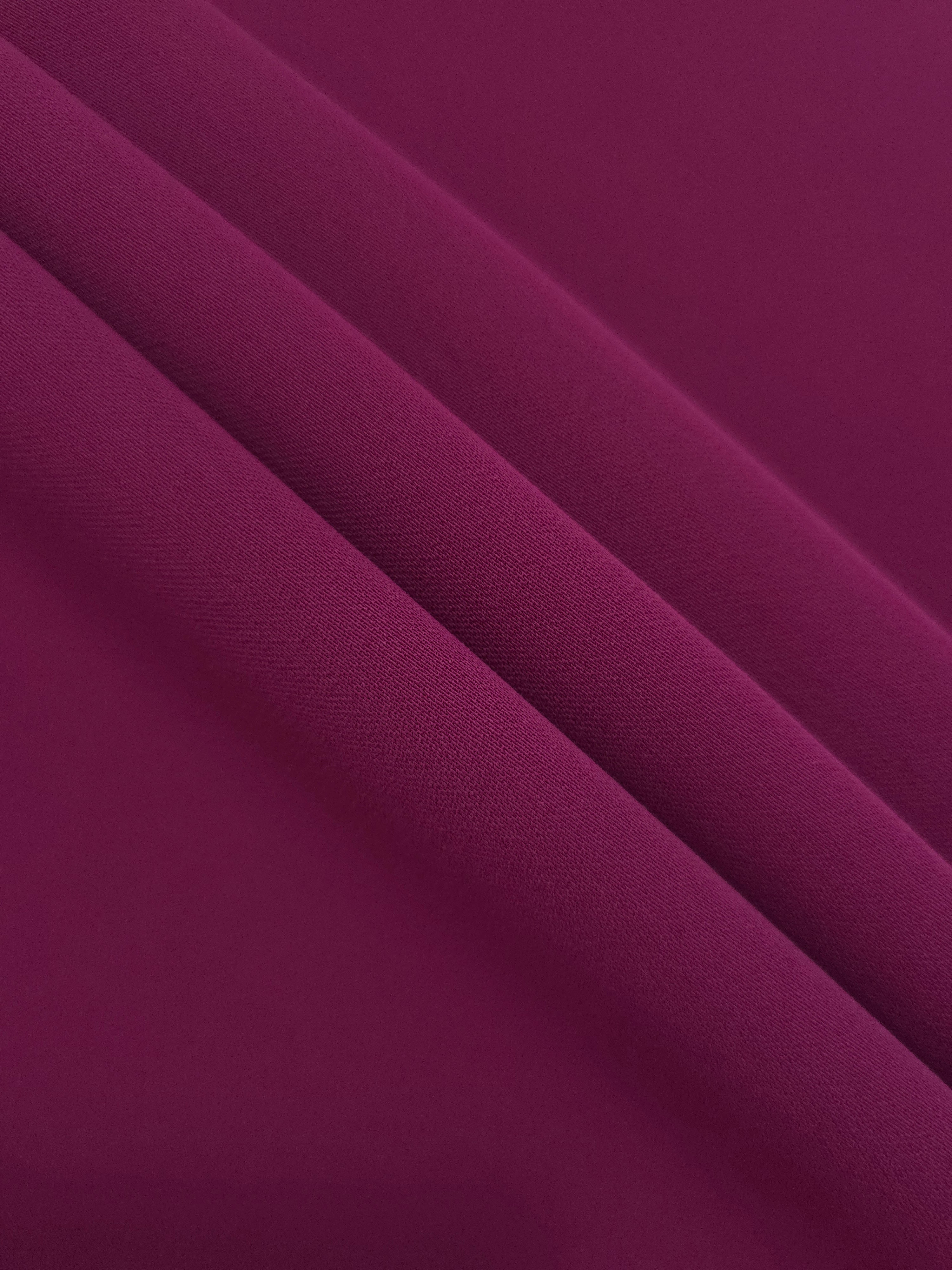 Layered Deep Wine Berry mechanical polyester crepe showing gentle stretch and soft structure for dressmaking