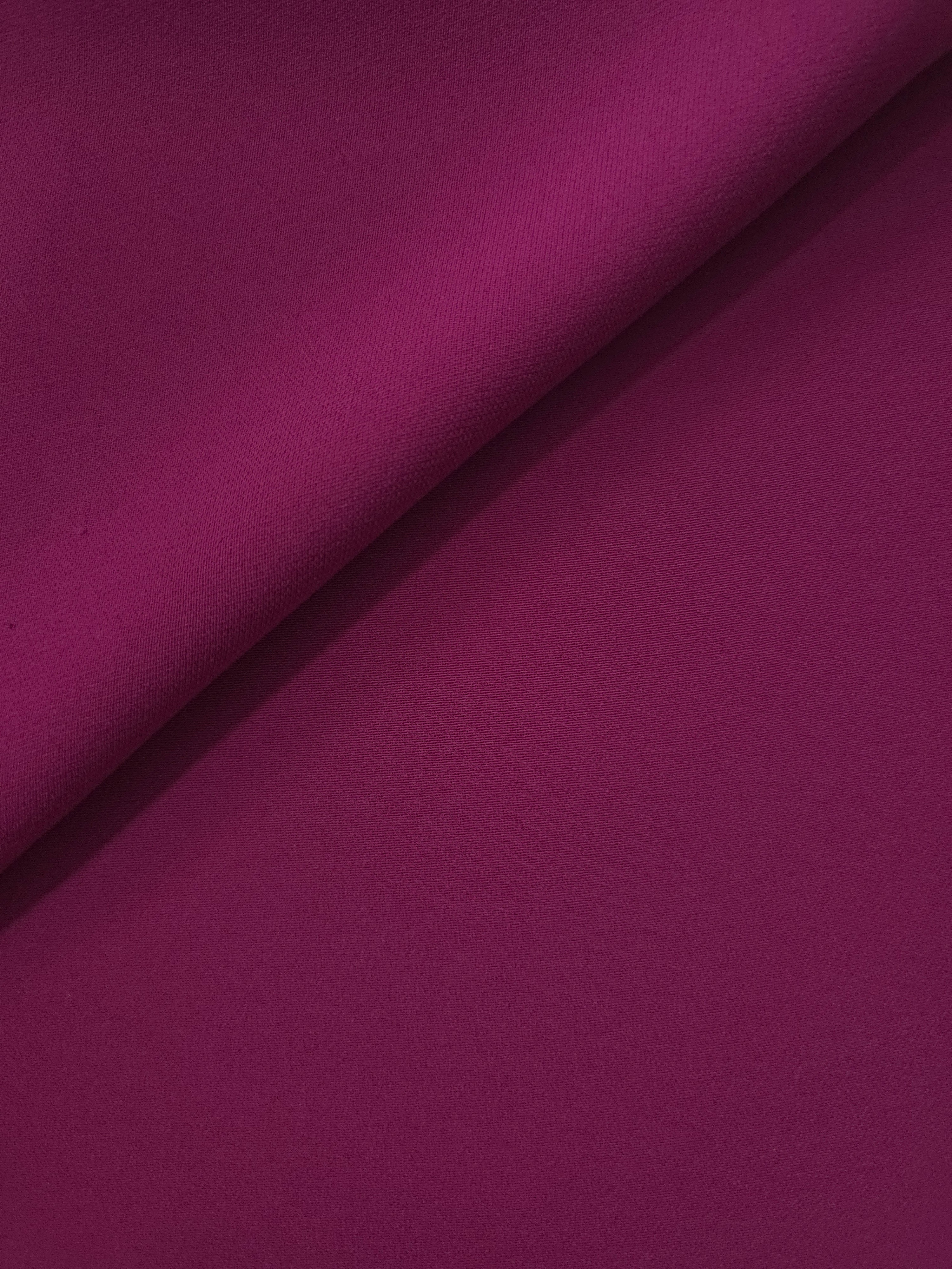 Deep Wine Berry polyester crepe in a soft fold, showing flowing drape for garment making and dressmaking