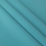 Layered Dusty Aqua Blue polyester crepe showing soft body and slight mechanical stretch for light tailoring