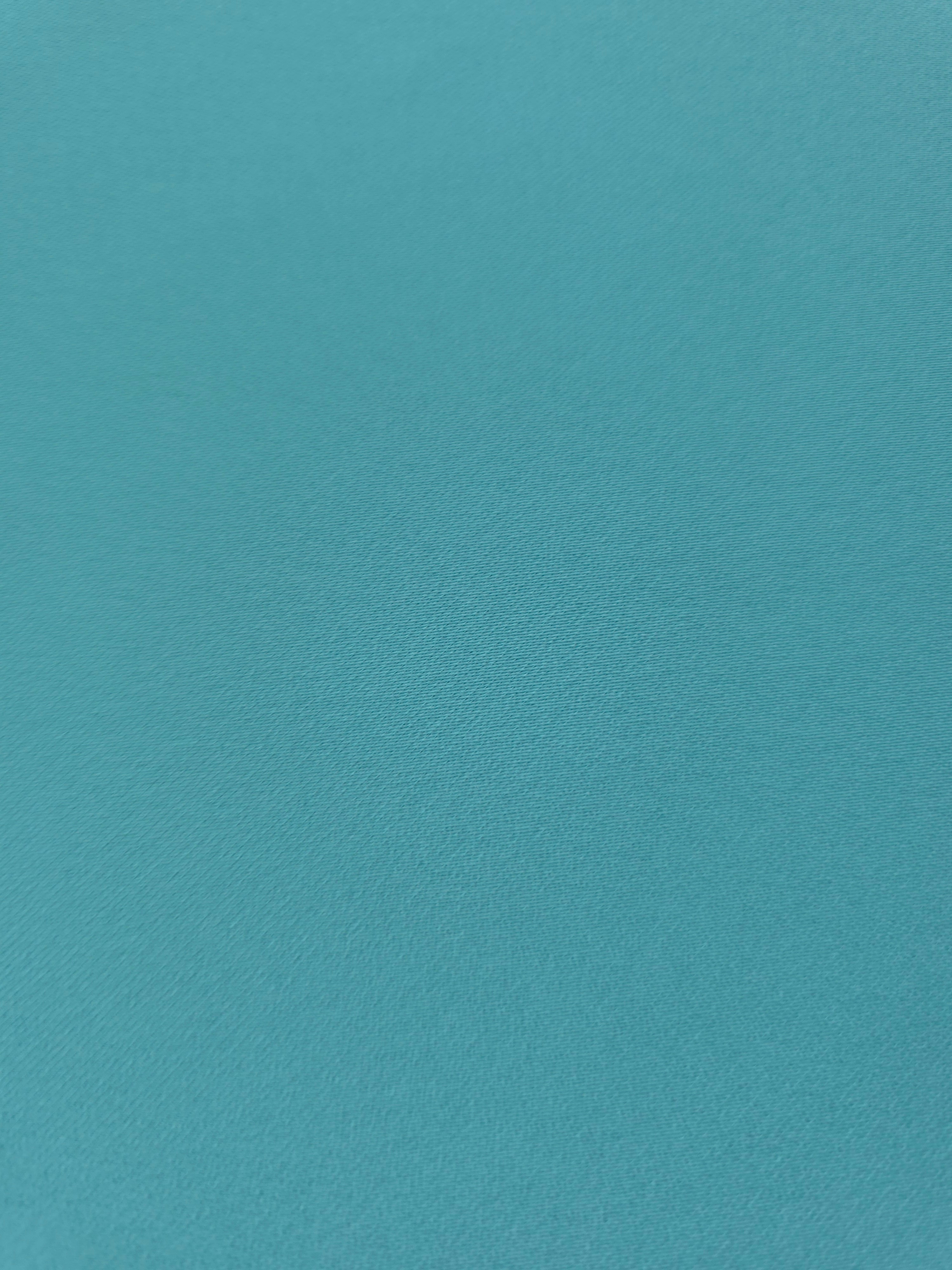 Fine texture close-up of Dusty Aqua Blue 100% mechanical polyester crepe showing a smooth, silky-soft woven hand