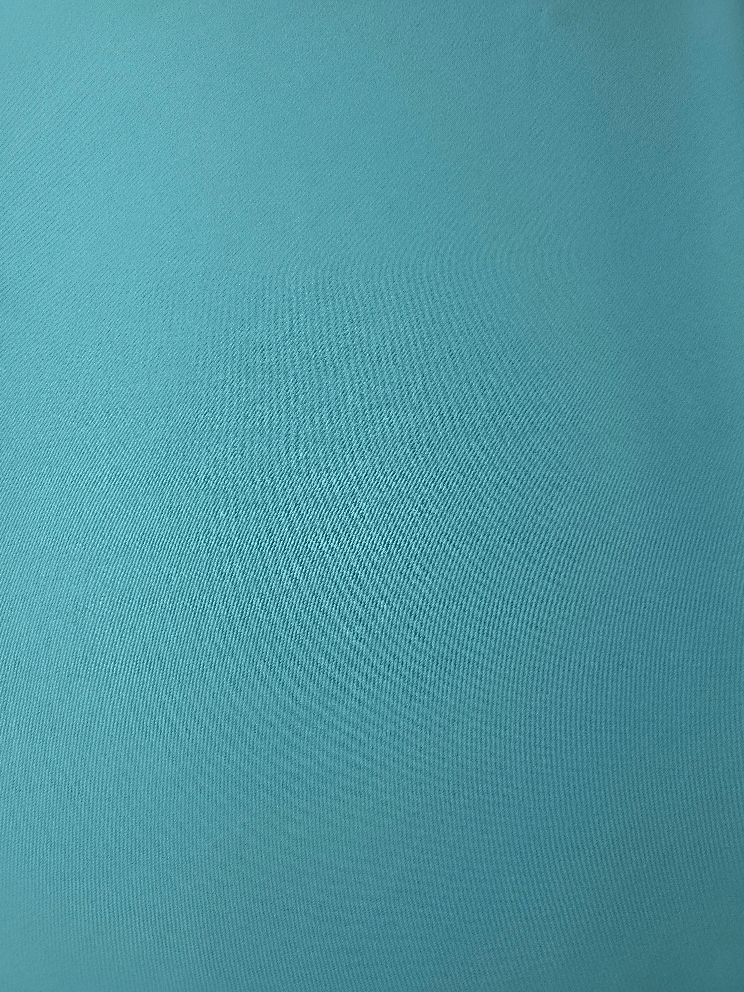 Flat surface of Dusty Aqua Blue Korean crepe, a 205 GSM opaque polyester fabric with smooth dressmaking character