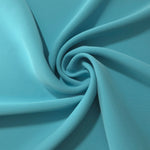 Circular drape of Dusty Aqua Blue polyester crepe showing flowing movement for occasion dresses and modest fashion