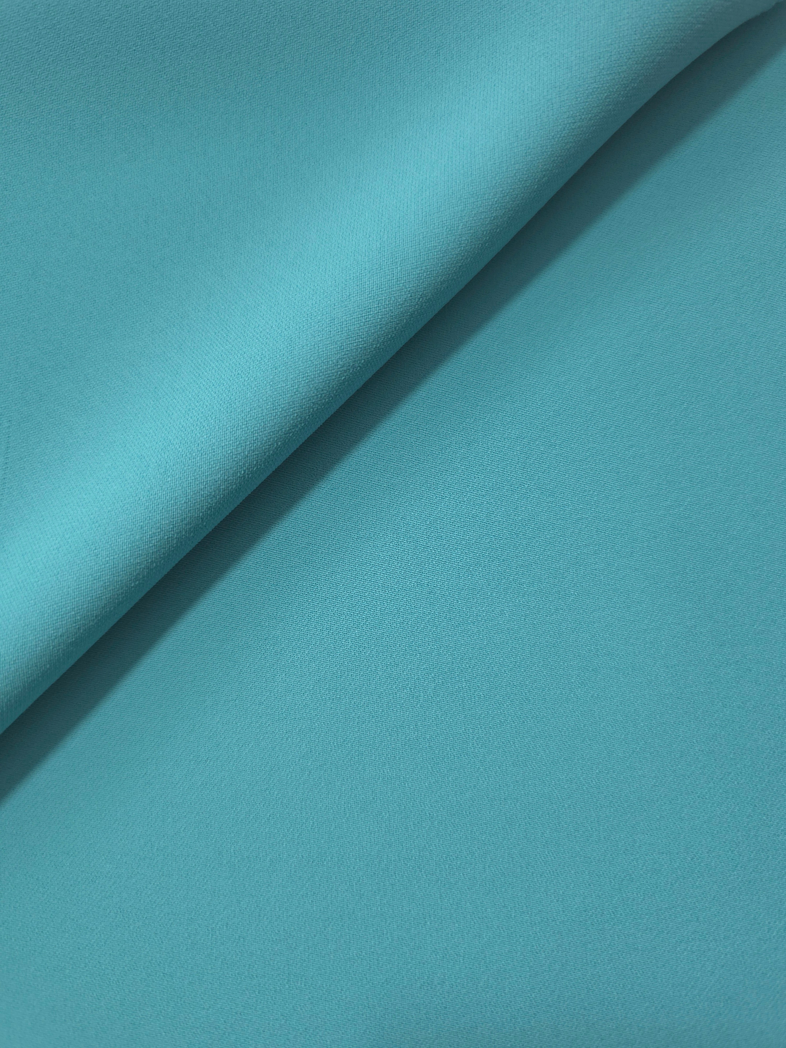 Soft-fold view of Dusty Aqua Blue Korean polyester crepe showing fluid drape for blouses, skirts and dresses