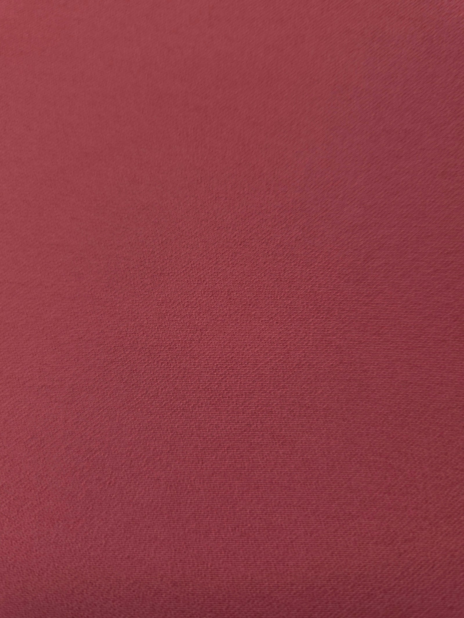 Texture detail of Dusty Burgundy mechanical polyester crepe, a smooth woven fabric with a soft silky hand