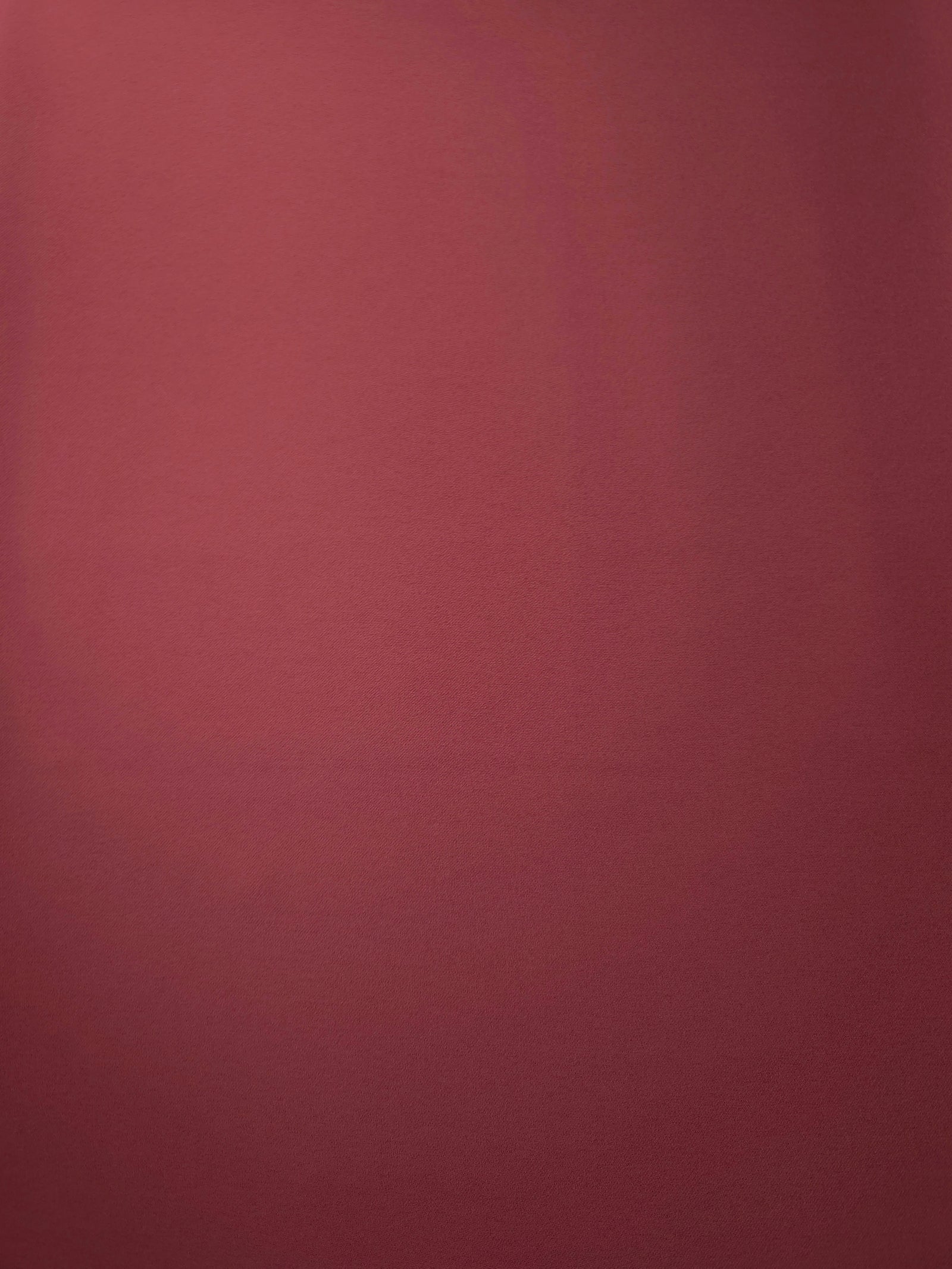 Dusty Burgundy Korean crepe fabric shown flat, 205 GSM opaque polyester with a smooth surface and silky-soft hand