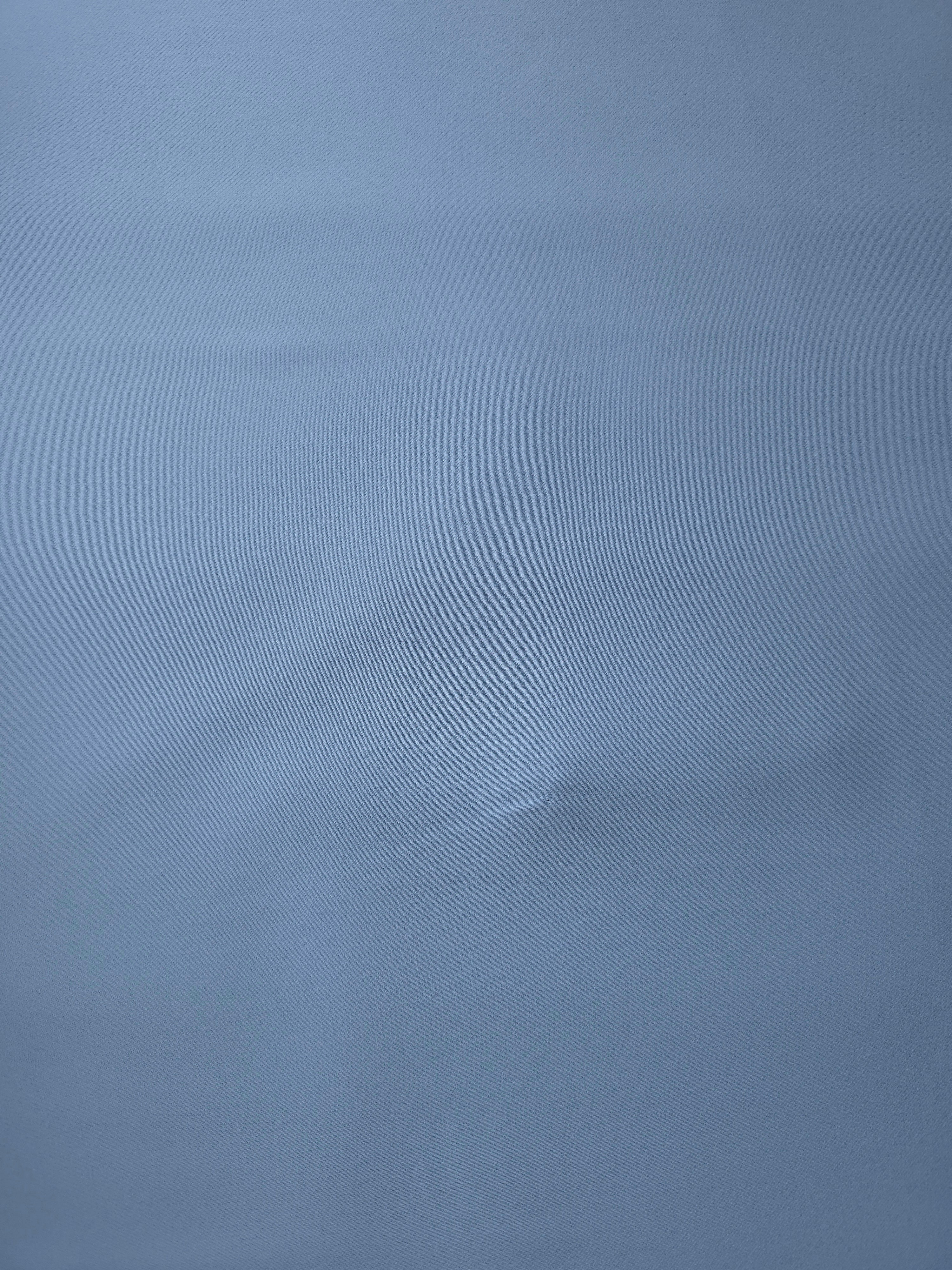 Dusty Denim Blue polyester crepe shown flat, a smooth woven apparel fabric with a refined soft-touch finish