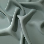 Draped Dusty Eucalyptus Green Korean polyester crepe showing opaque fluid folds for evening dresses and occasionwear