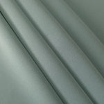 Layered Dusty Eucalyptus Green mechanical polyester crepe showing soft structure and slight mechanical stretch for tailoring