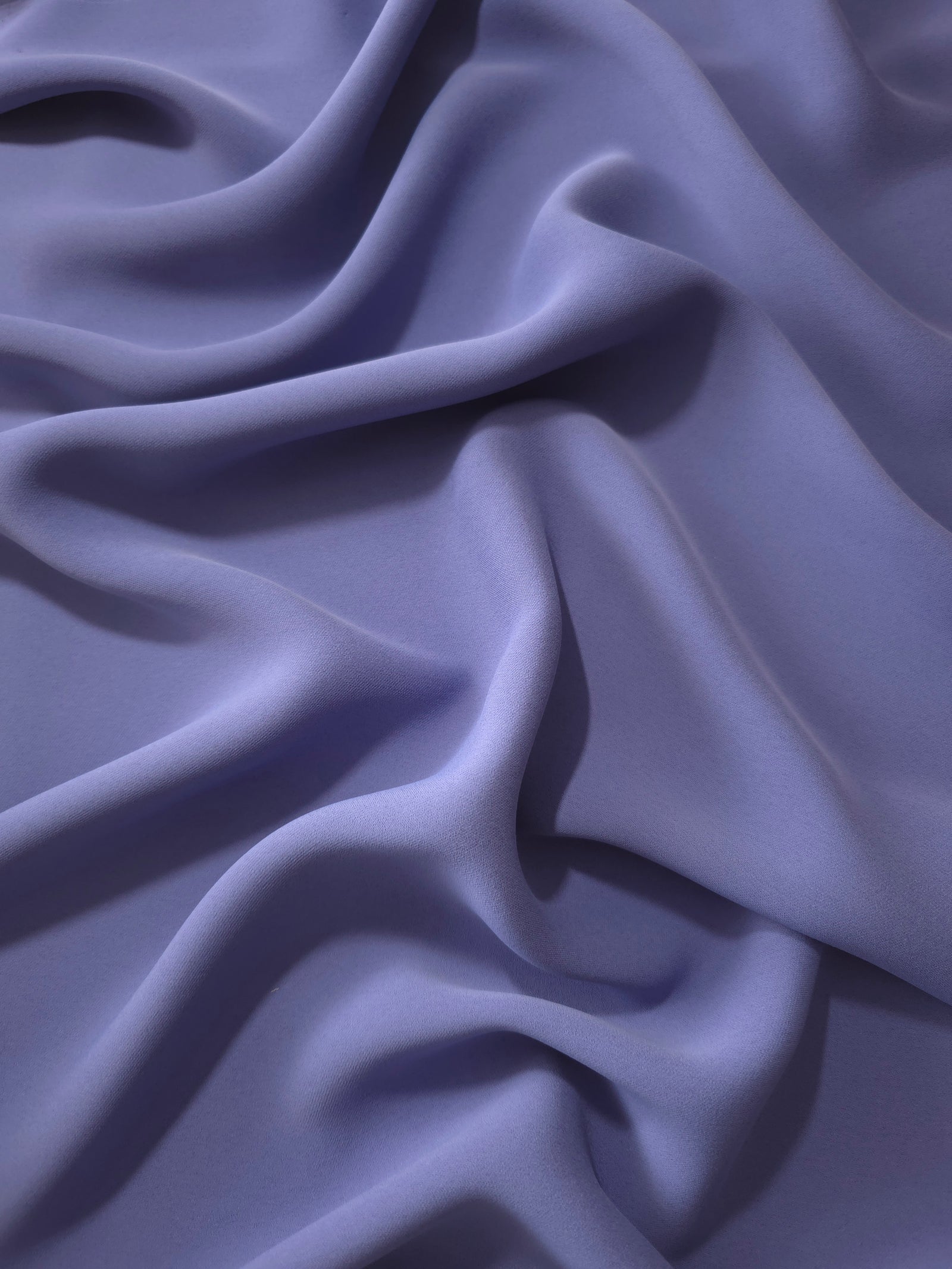 Fluid folds of Dusty Indigo Blue opaque Korean crepe, a dress fabric suited to eveningwear and flowing skirts