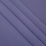Layered folds of Dusty Indigo Blue 100% mechanical polyester crepe showing body and gentle construction stretch