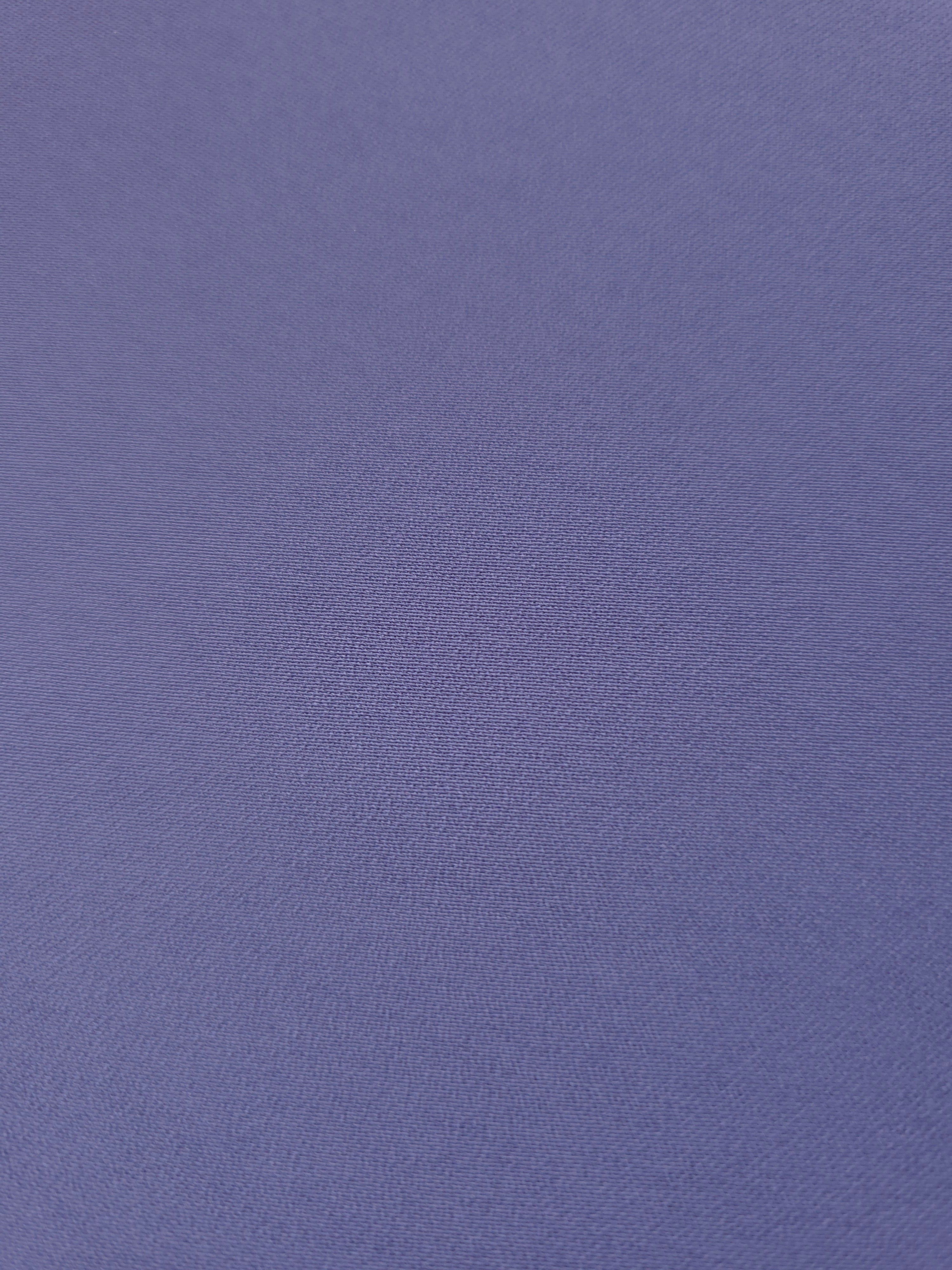 Texture detail of Dusty Indigo Blue mechanical polyester crepe, a smooth woven fabric with a soft silky hand