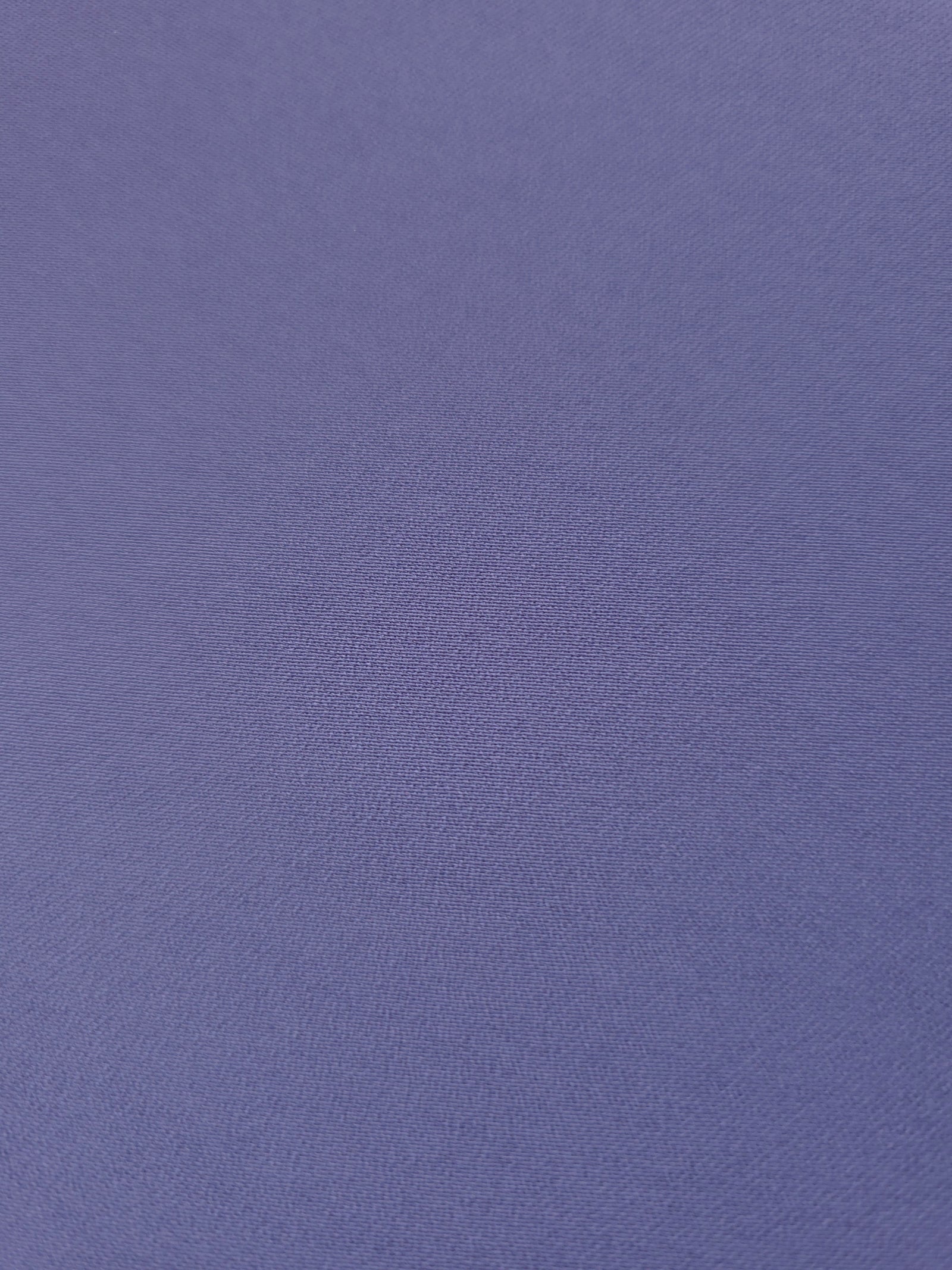 Texture detail of Dusty Indigo Blue mechanical polyester crepe, a smooth woven fabric with a soft silky hand