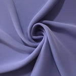 Dusty Indigo Blue opaque polyester crepe in a spiral drape, showing flowing form for skirts and modest garments
