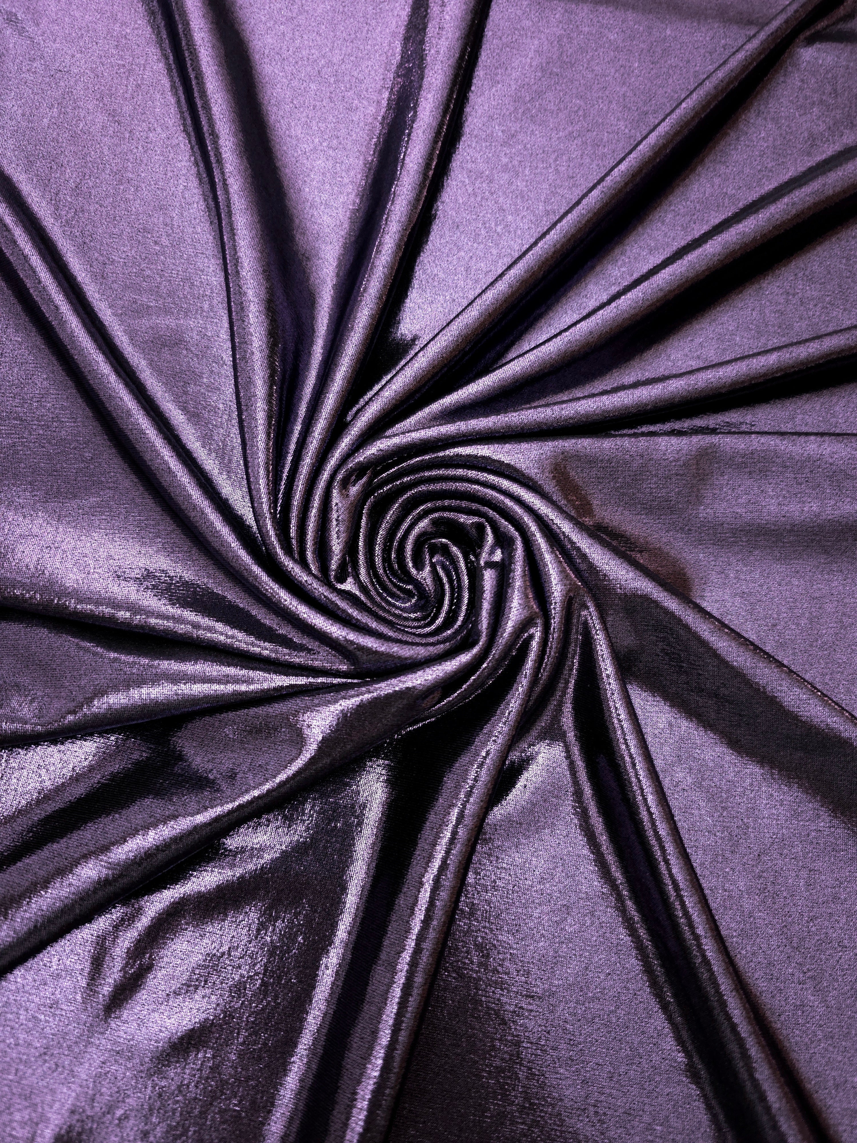 Flowing swirl of Dusty Lavender Purple metallic stretch fabric, showing dynamic foil reflection for stagewear, skirts and creative fashion