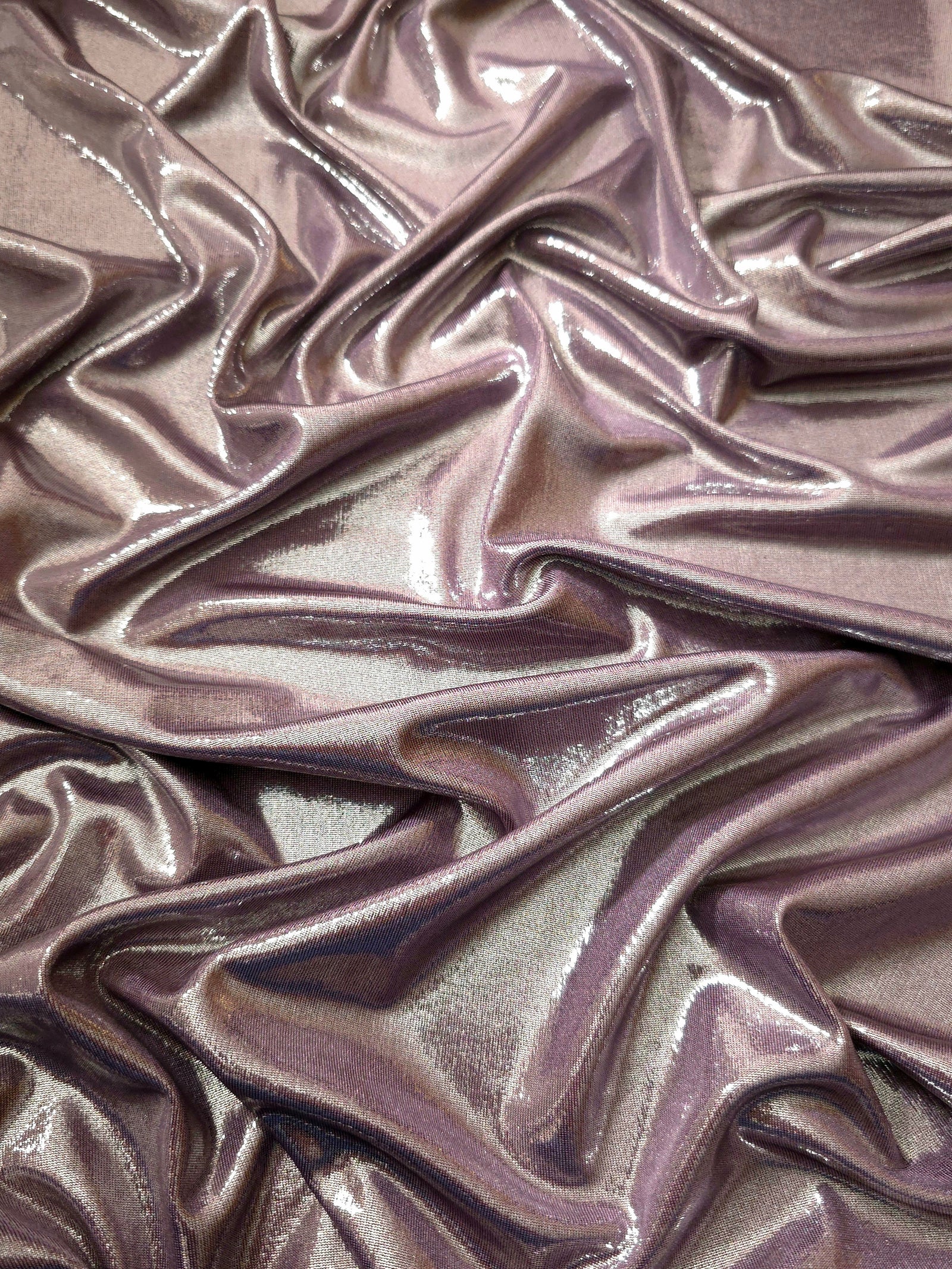 Draped Dusty Mauve Gray metallic foiled spandex showing reflective folds and flexible flow for dresses, stagewear and occasion looks
