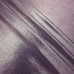 Layered folds of Dusty Mauve Gray foiled stretch fabric showing shimmer, body and movement for performance outfits and statement garments