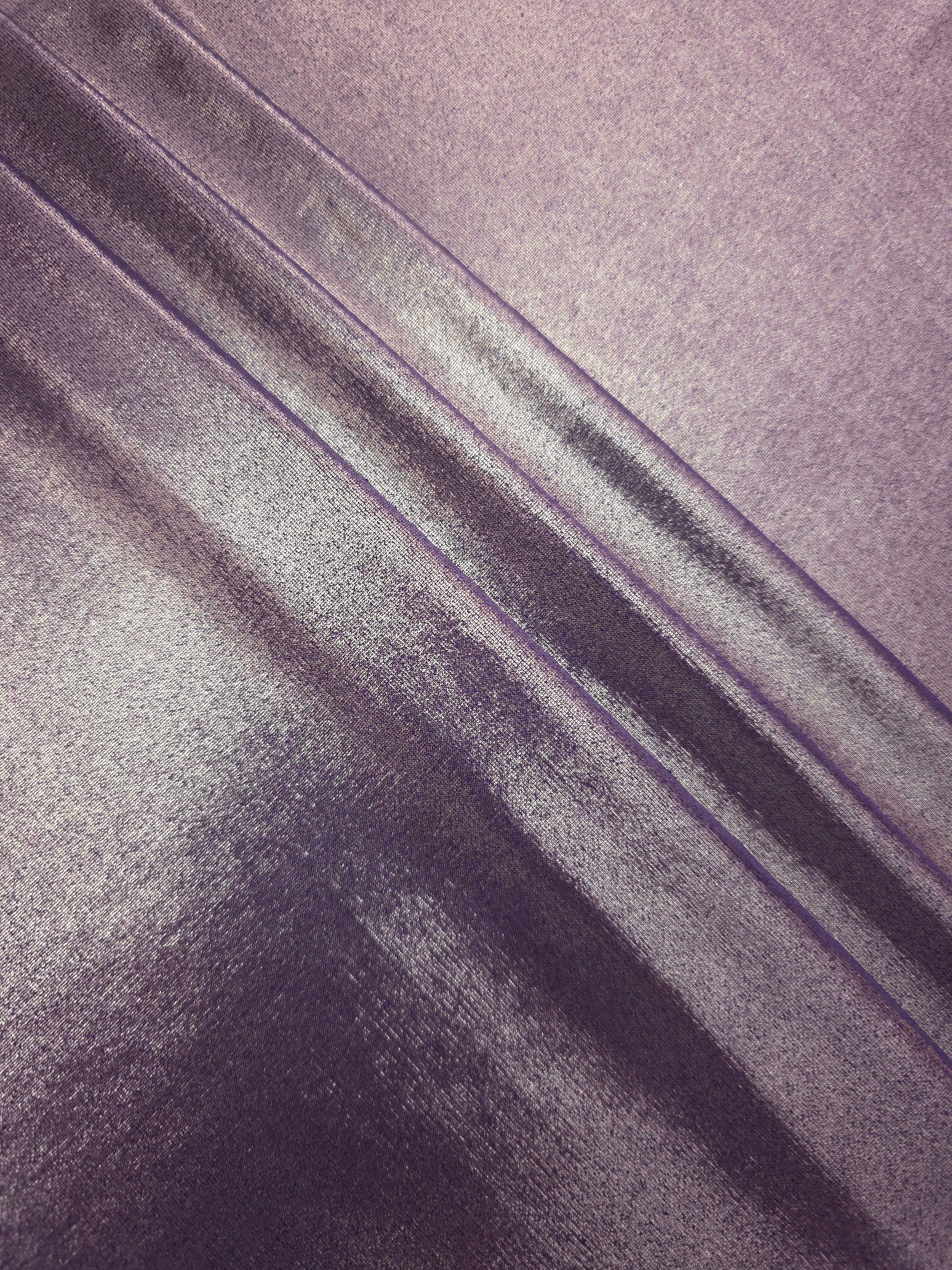 Layered folds of Dusty Mauve Gray foiled stretch fabric showing shimmer, body and movement for performance outfits and statement garments