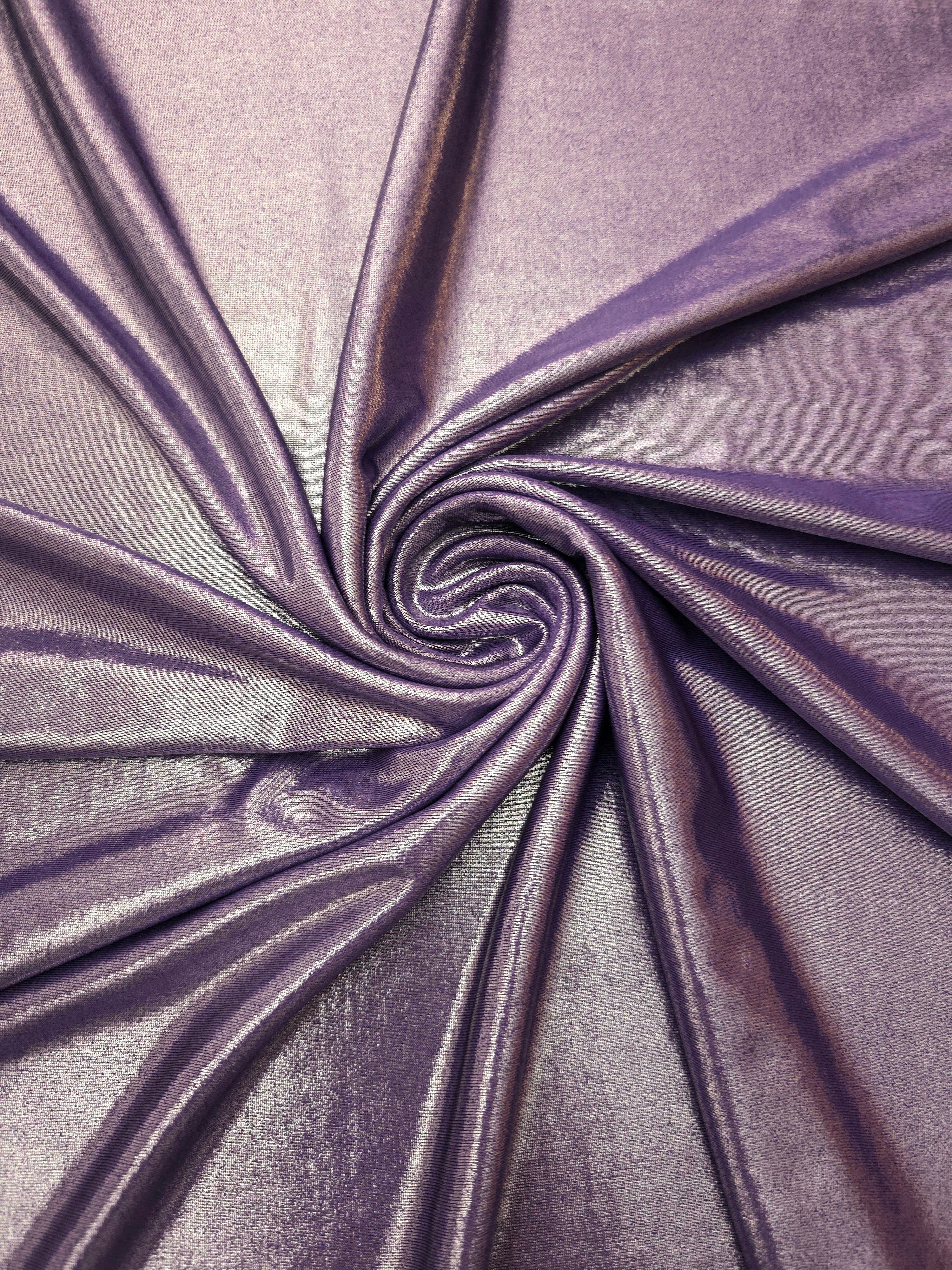 Dusty Mauve Gray metallic stretch fabric in a flowing swirl, emphasizing foil shimmer and drape for partywear and statement fashion