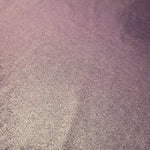 Detailed close-up of Dusty Mauve Gray foiled spandex fabric showing its luminous metallic surface and fine reflective texture