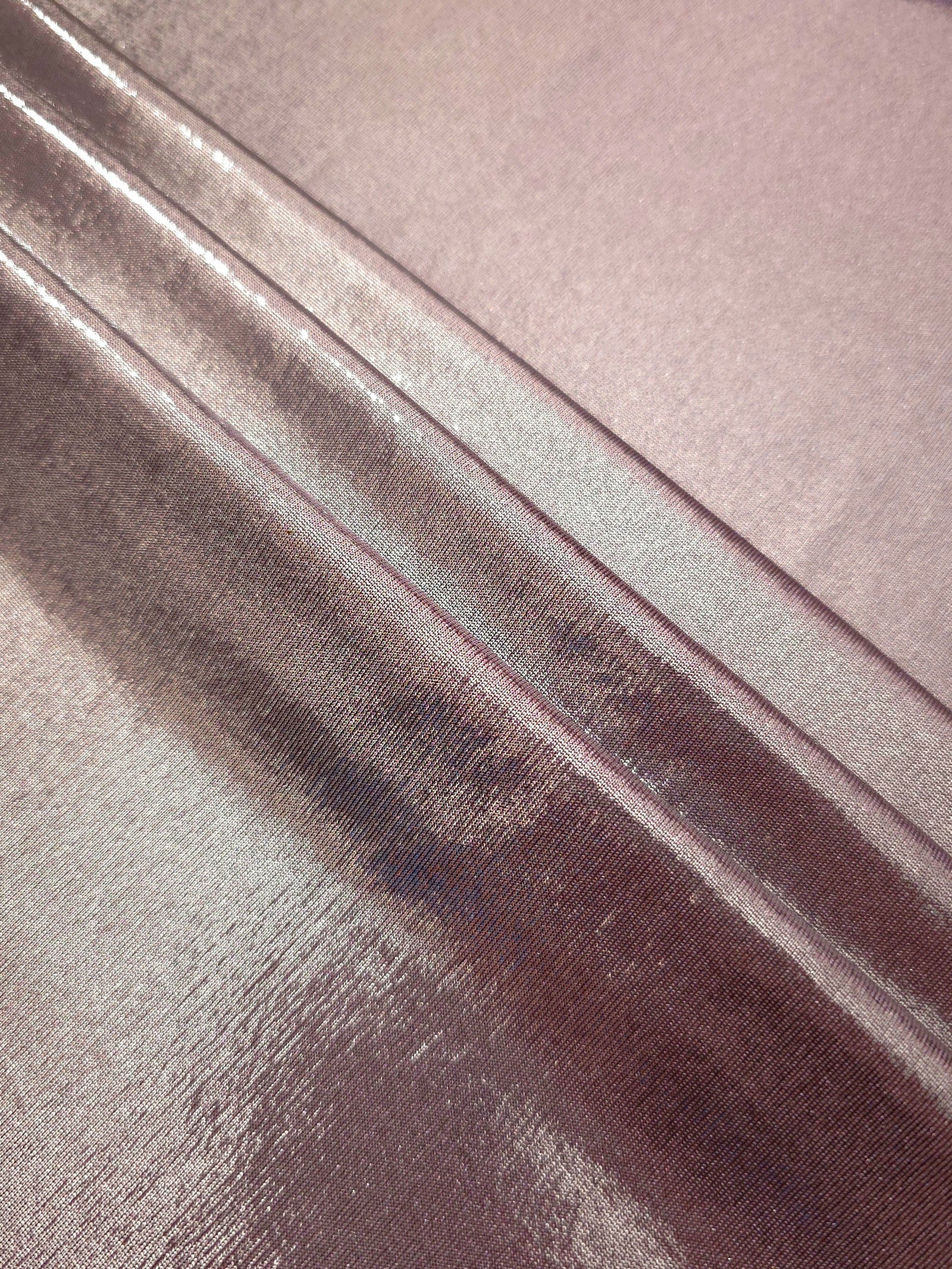 Layered Dusty Mauve Gray shimmer stretch fabric showing metallic foil depth and soft structure for costumes, skirts and fashion apparel