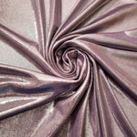 Dusty Mauve Gray shimmer foiled stretch fabric arranged in a swirl, highlighting movement and reflective finish for performancewear