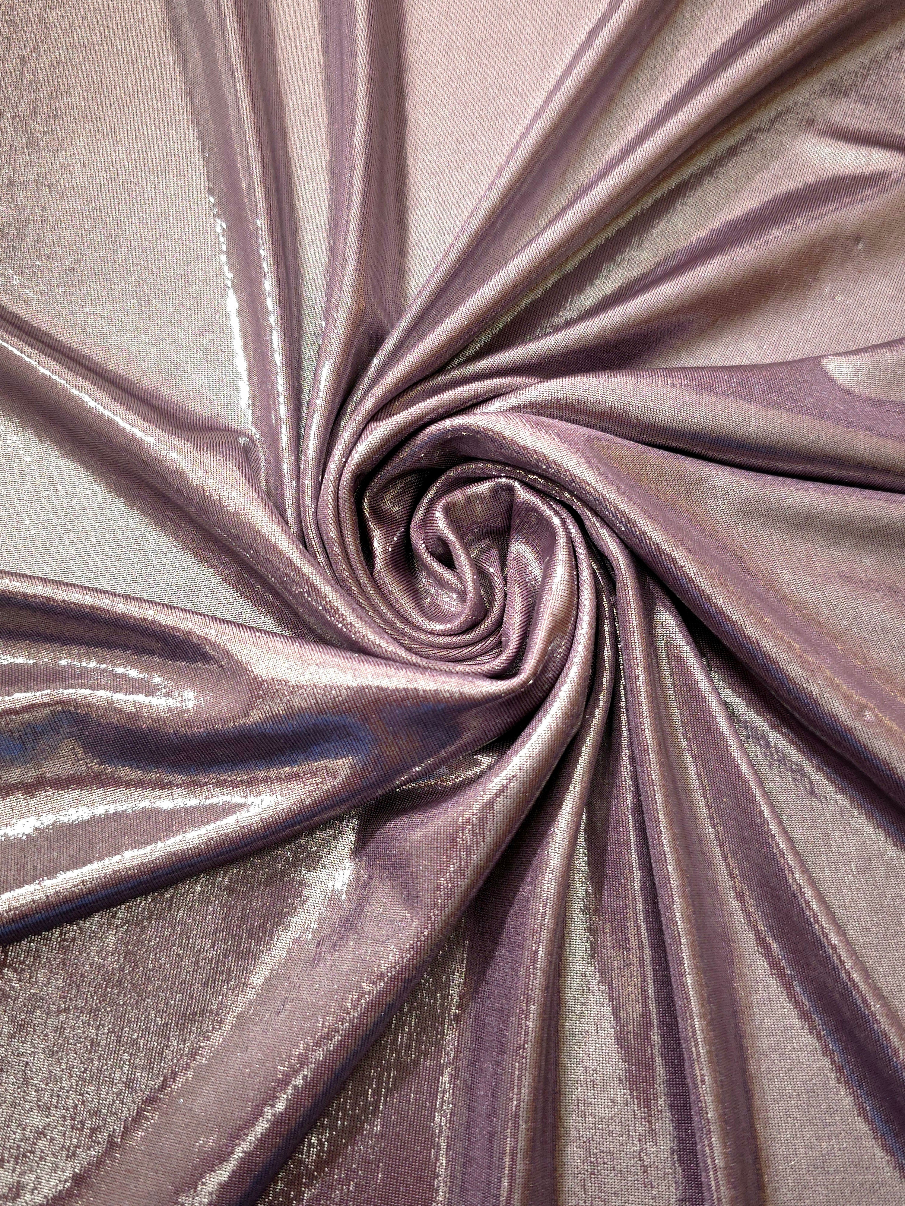 Dusty Mauve Gray shimmer foiled stretch fabric arranged in a swirl, highlighting movement and reflective finish for performancewear