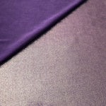 Dusty Mauve Gray foiled stretch fabric in a gentle fold, showing metallic shimmer and flexibility for partywear and performance fashion
