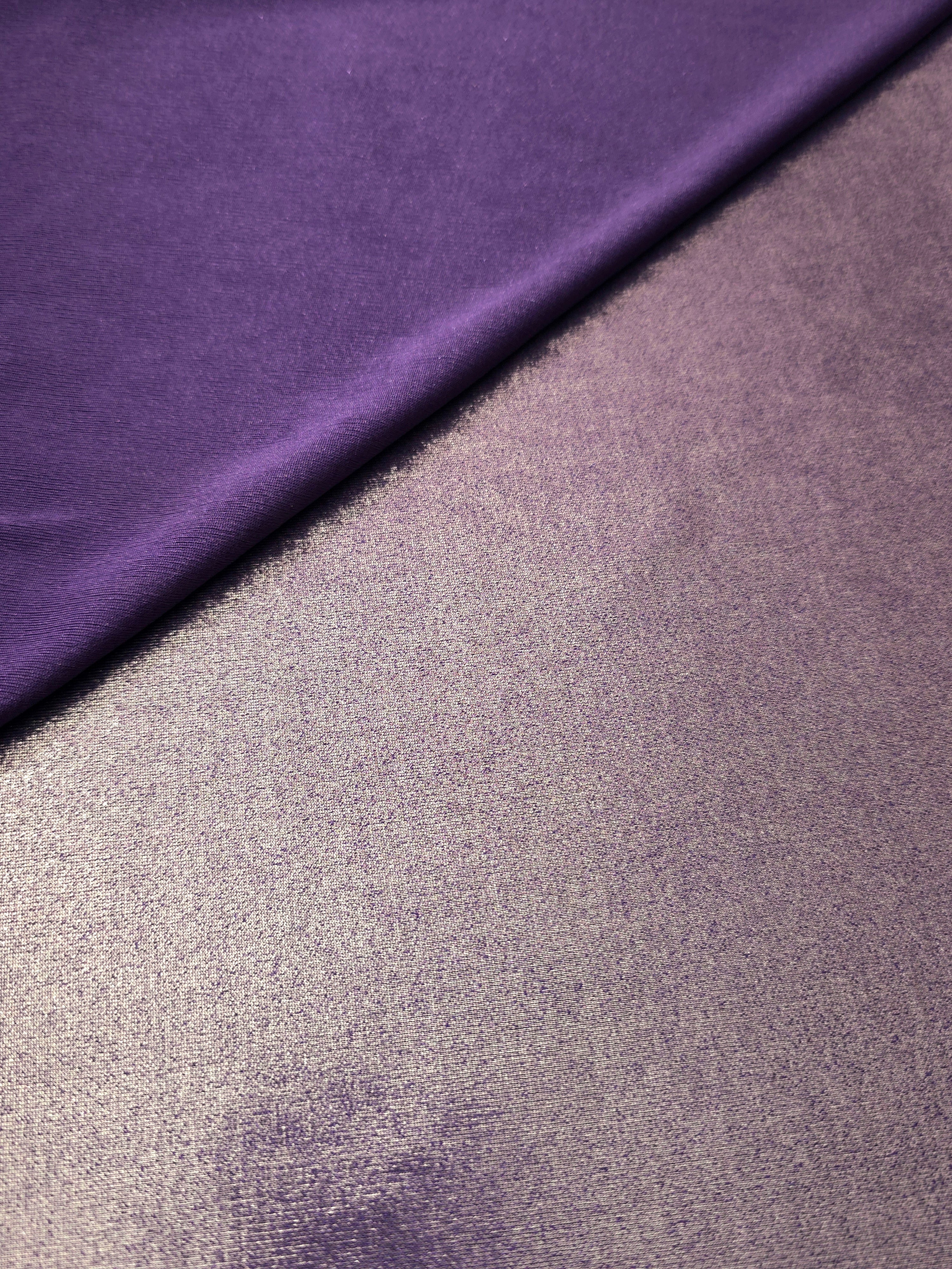 Dusty Mauve Gray foiled stretch fabric in a gentle fold, showing metallic shimmer and flexibility for partywear and performance fashion