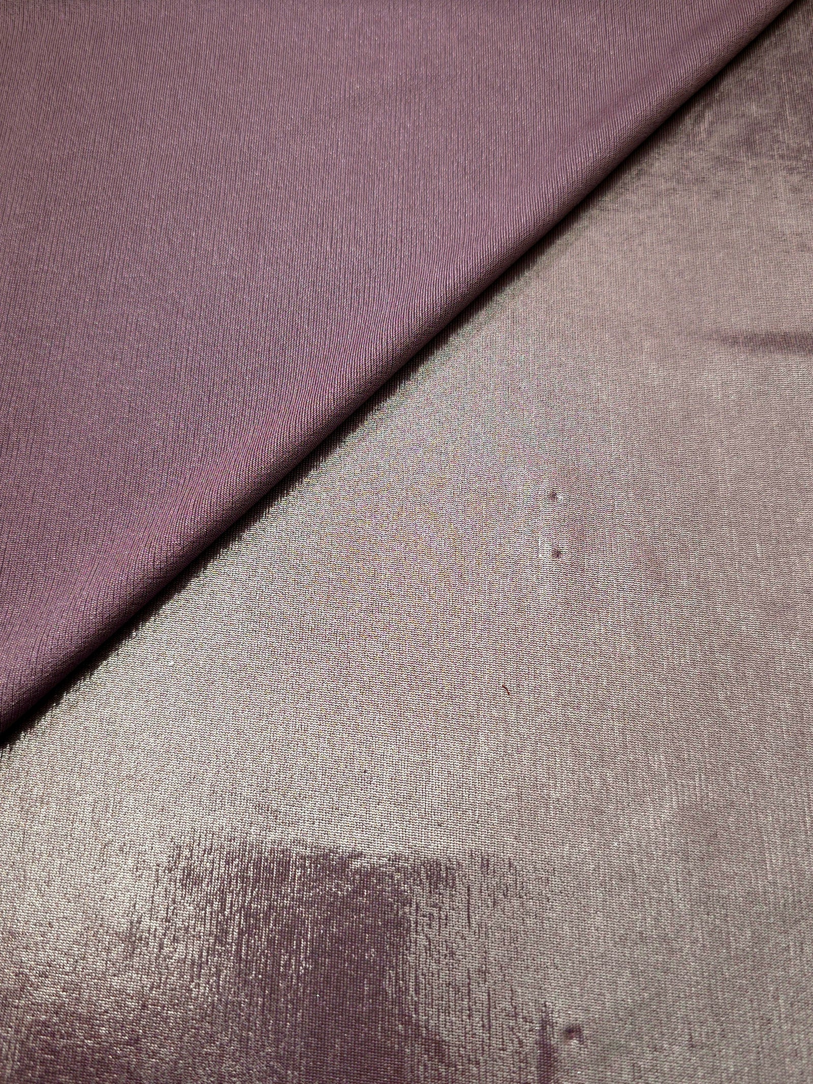 Dusty Mauve Gray shimmer spandex in a soft fold, showing metallic foil sheen and flexible drape for tops, skirts and costumes