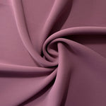 Dusty Mauve silky-soft polyester crepe styled in a swirl to show fluid dressmaking drape and movement