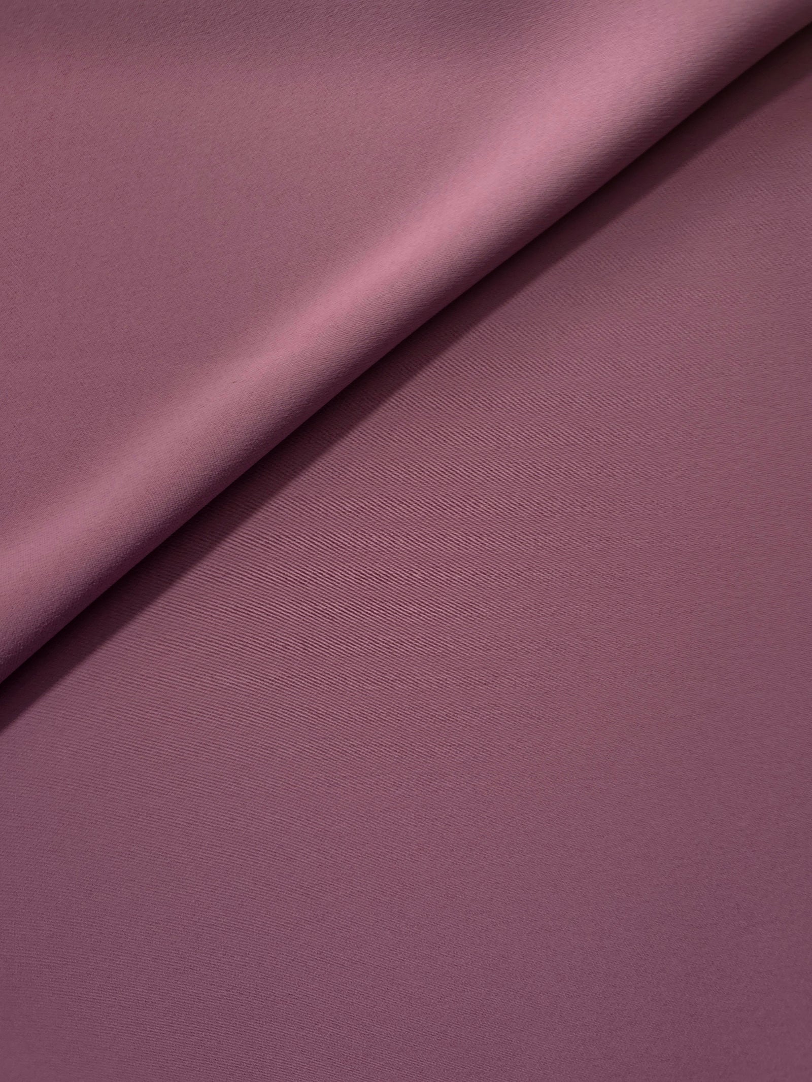 Dusty Mauve opaque Korean polyester crepe in a soft fold, showing flowing drape for garment making