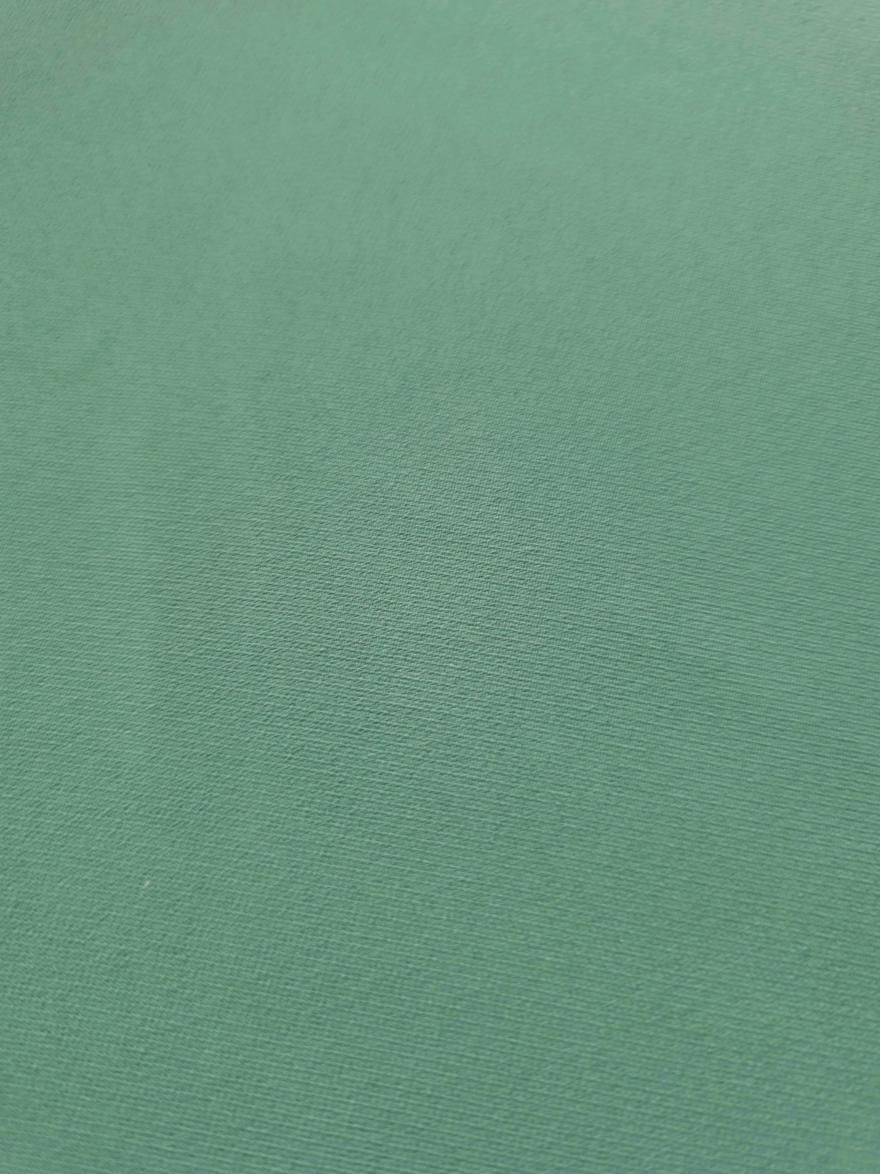 Woven close-up of Dusty Mint Green mechanical polyester crepe showing smooth texture and a soft silky-feel finish
