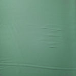 Dusty Mint Green Korean polyester crepe in a flat surface view, 205 GSM opaque fabric for dresses and separates