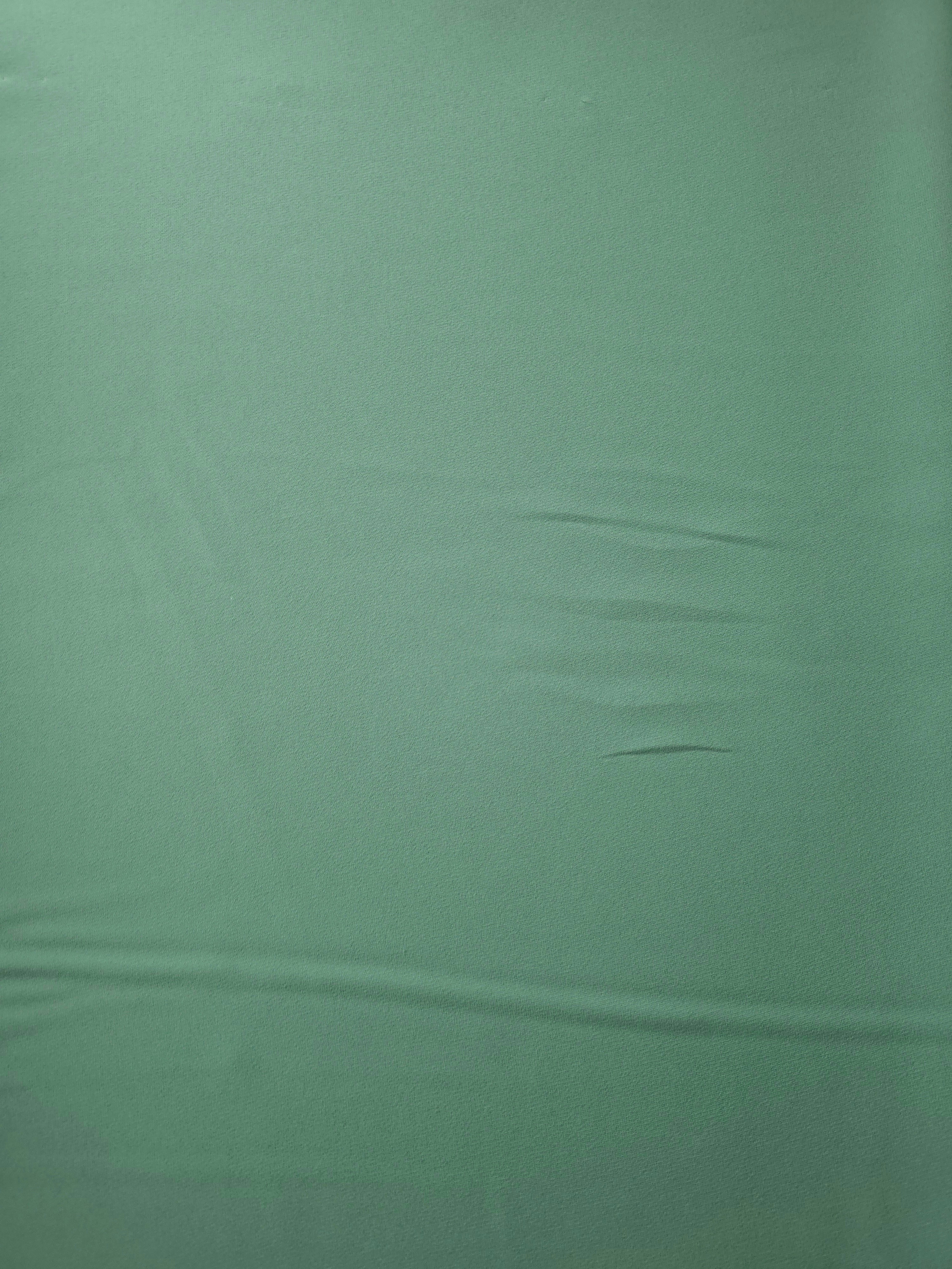 Dusty Mint Green Korean polyester crepe in a flat surface view, 205 GSM opaque fabric for dresses and separates