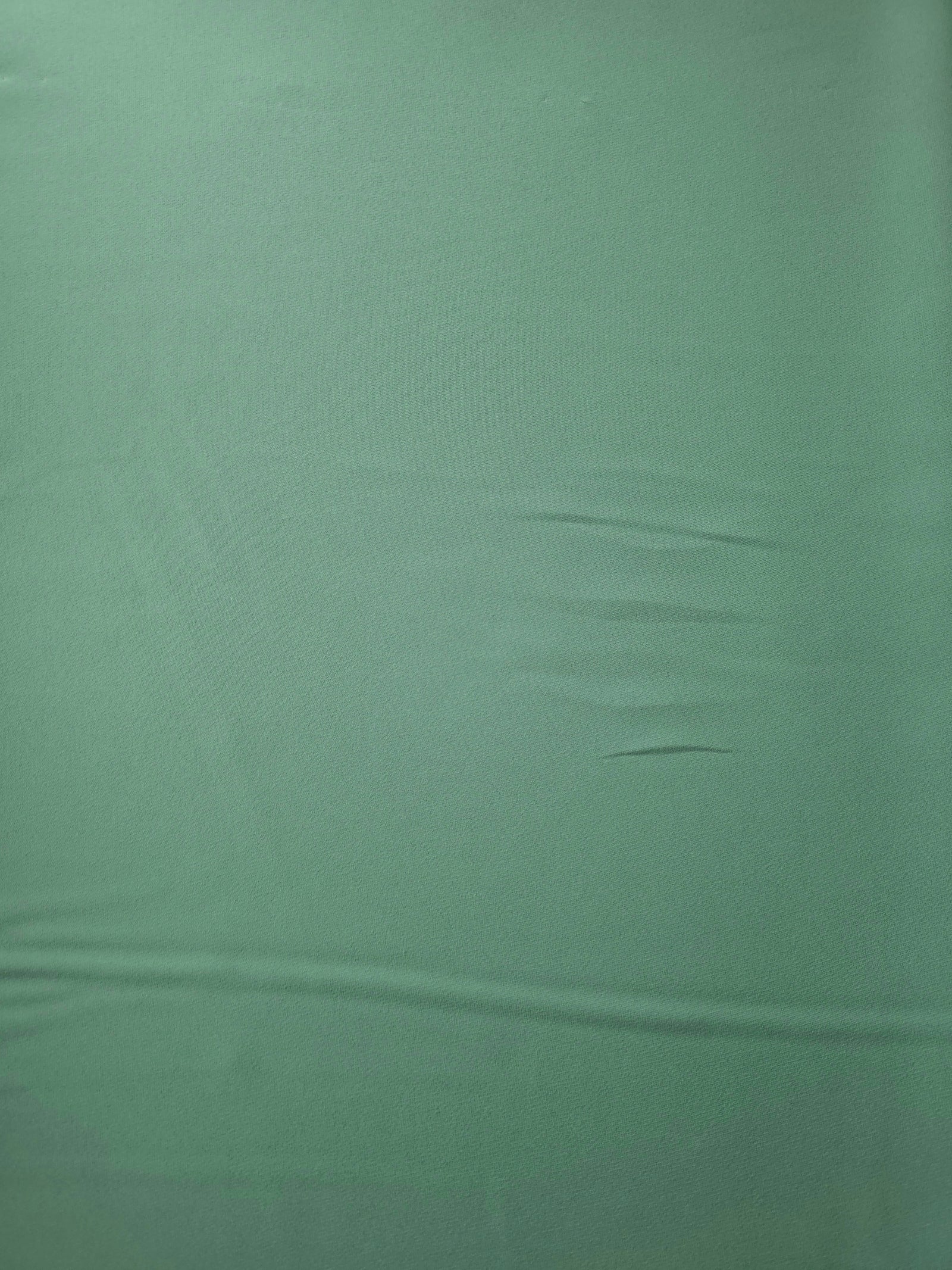 Dusty Mint Green Korean polyester crepe in a flat surface view, 205 GSM opaque fabric for dresses and separates