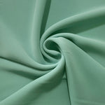 Spiral styling of Dusty Mint Green Korean polyester crepe showing supple drape for abayas, dresses and occasionwear