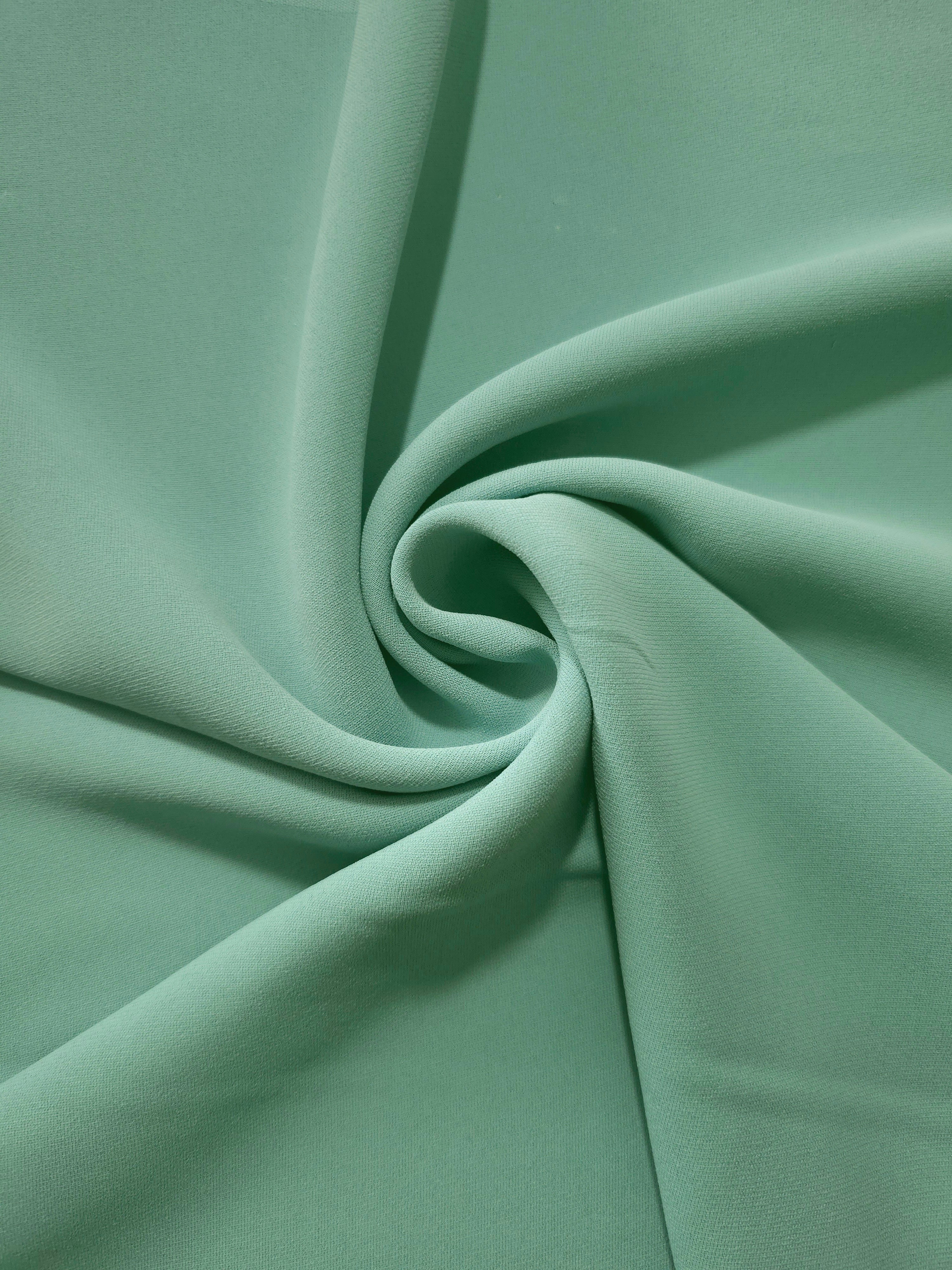 Spiral styling of Dusty Mint Green Korean polyester crepe showing supple drape for abayas, dresses and occasionwear