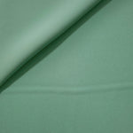 Dusty Mint Green polyester crepe gathered into a soft fold, showing fluid drape for dresses and blouse making