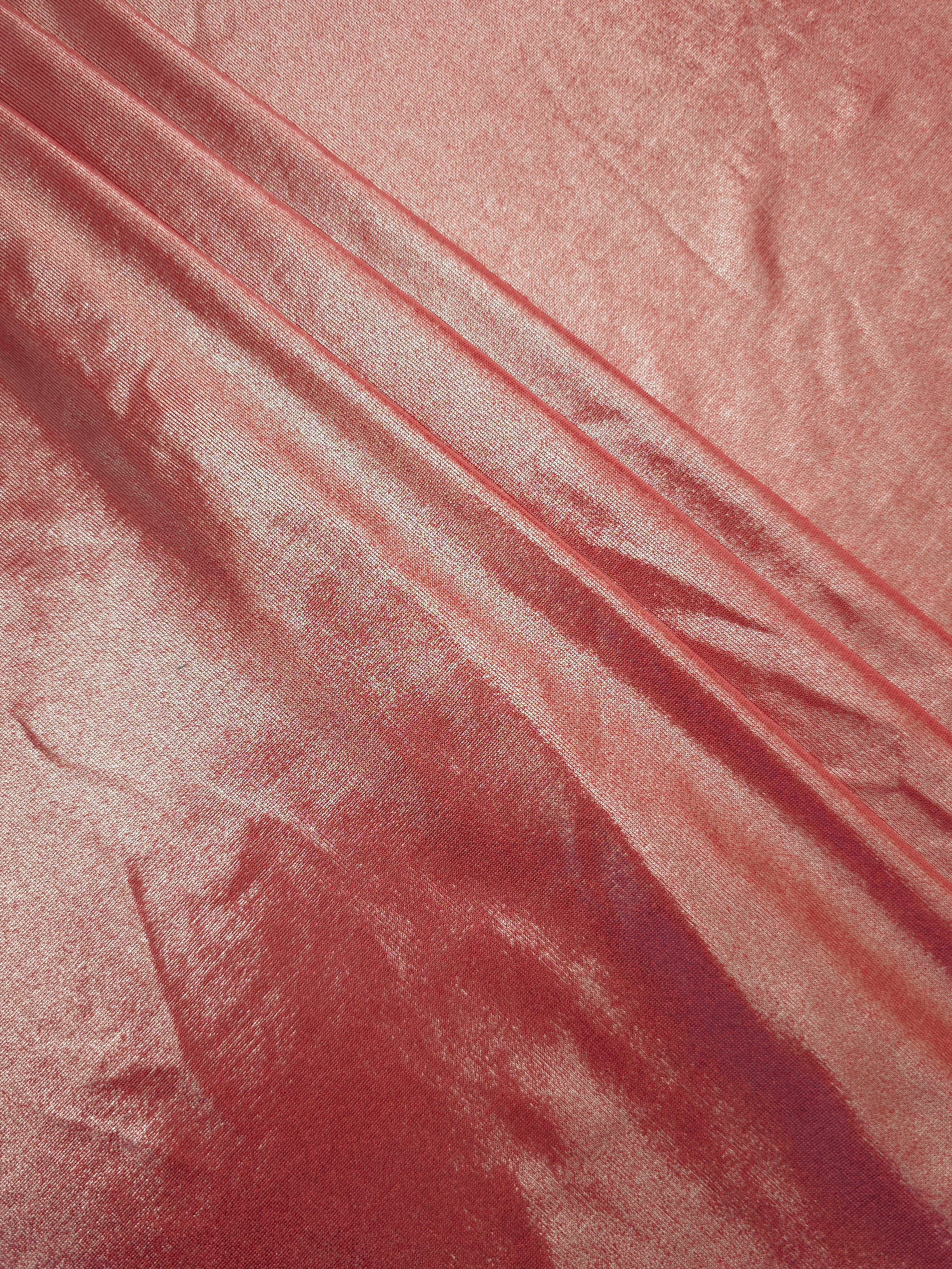 Dusty Peach Pink foiled spandex arranged in layered folds, displaying shimmer and soft structure for skirts, tops and performancewear