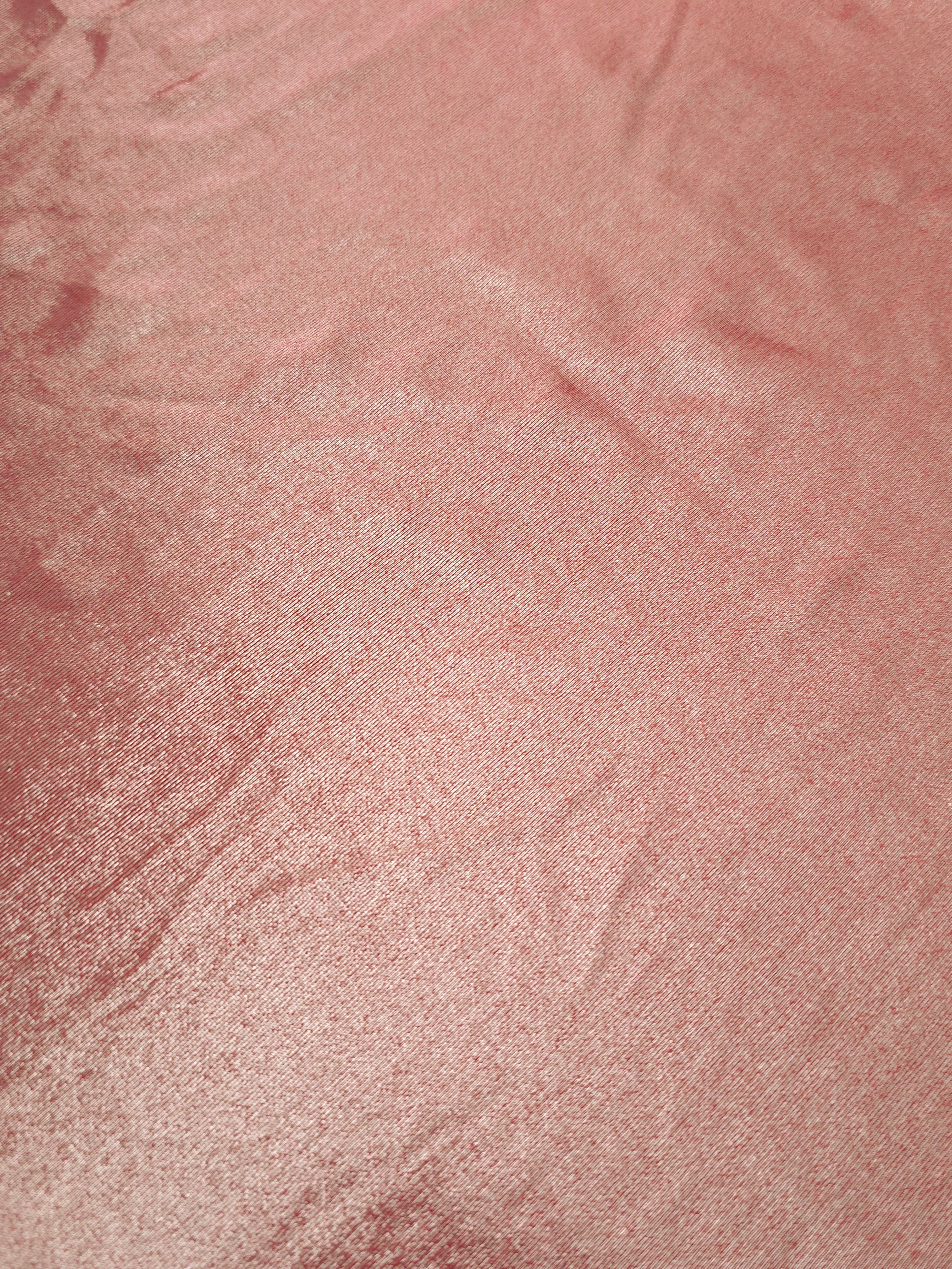 Dusty Peach Pink foiled stretch fabric texture close-up, displaying metallic reflection and fine surface character for apparel design
